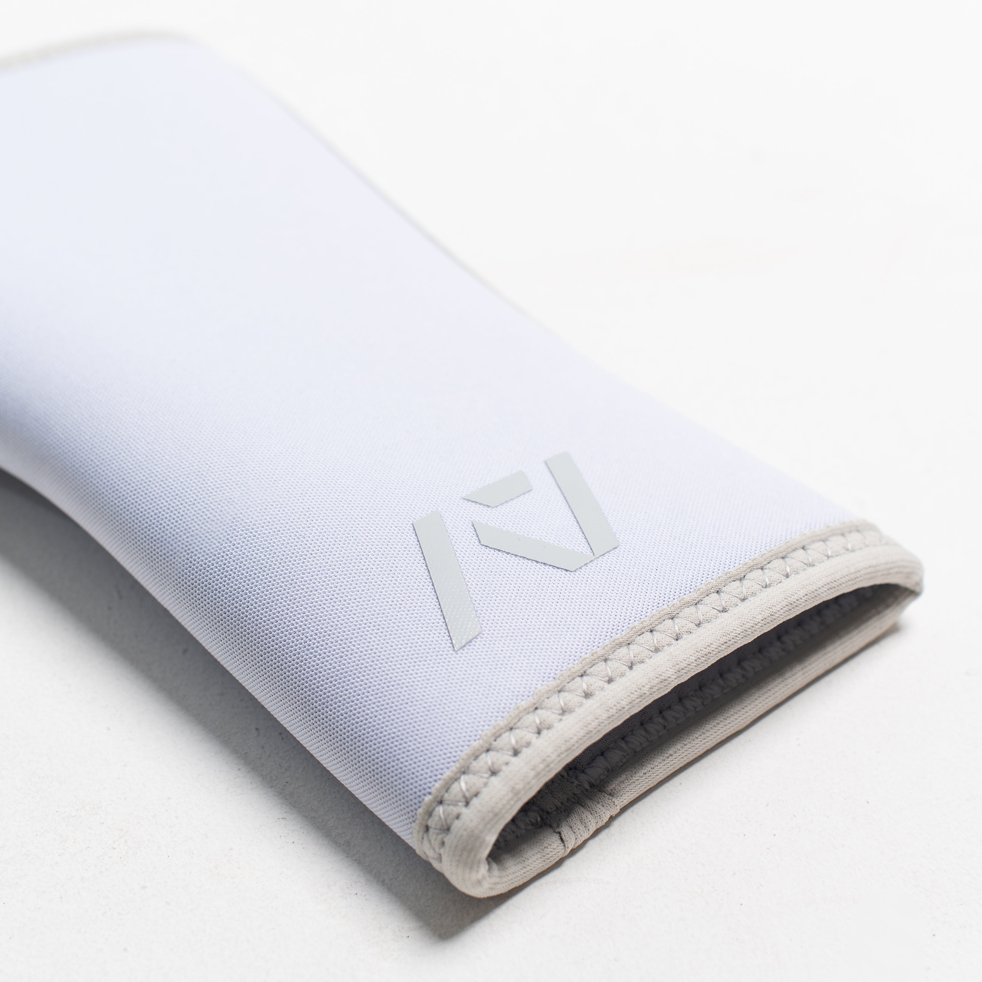 Close up of flatlay of stiff hourglass knee sleeve