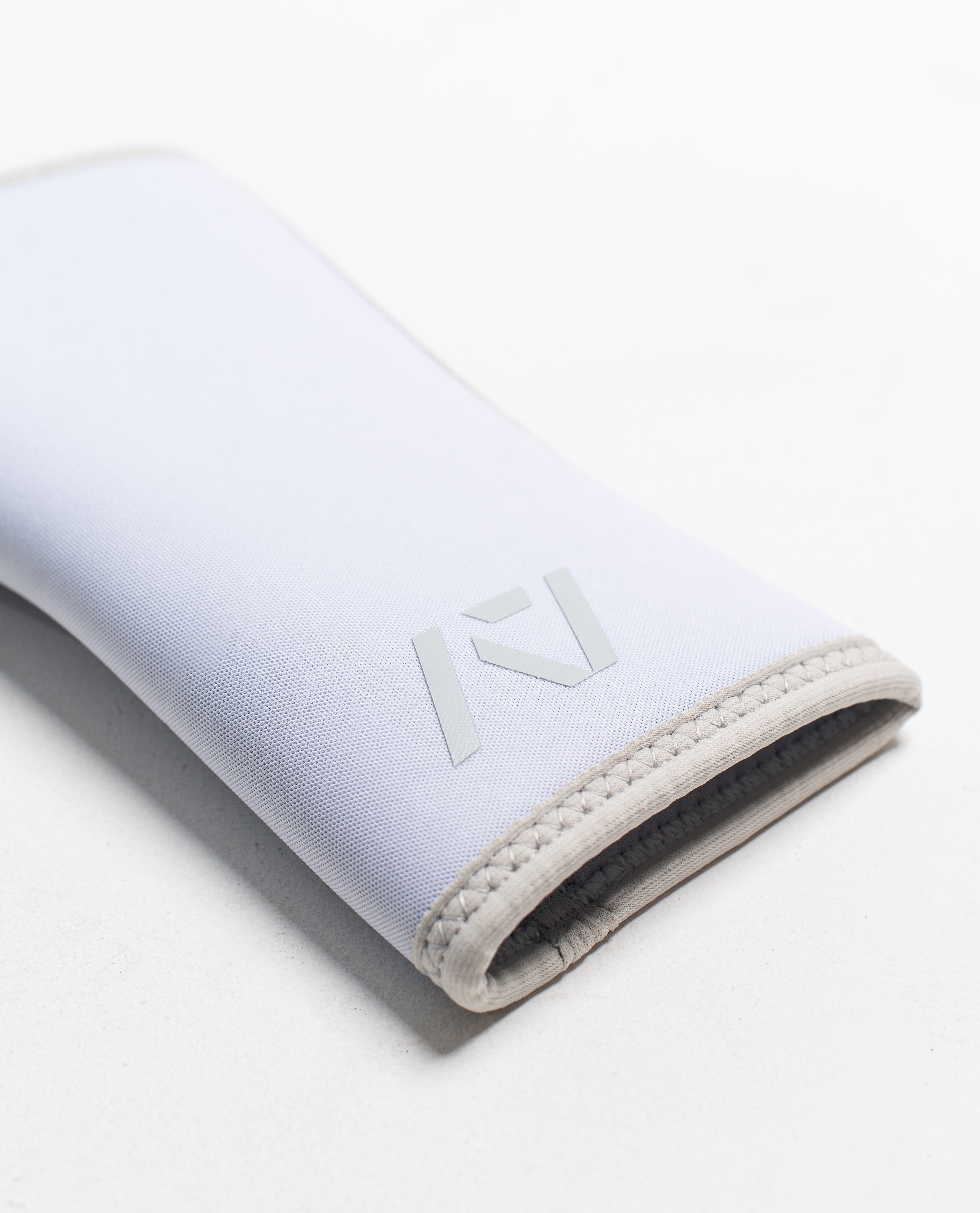 Close up of flatlay of stiff hourglass knee sleeve