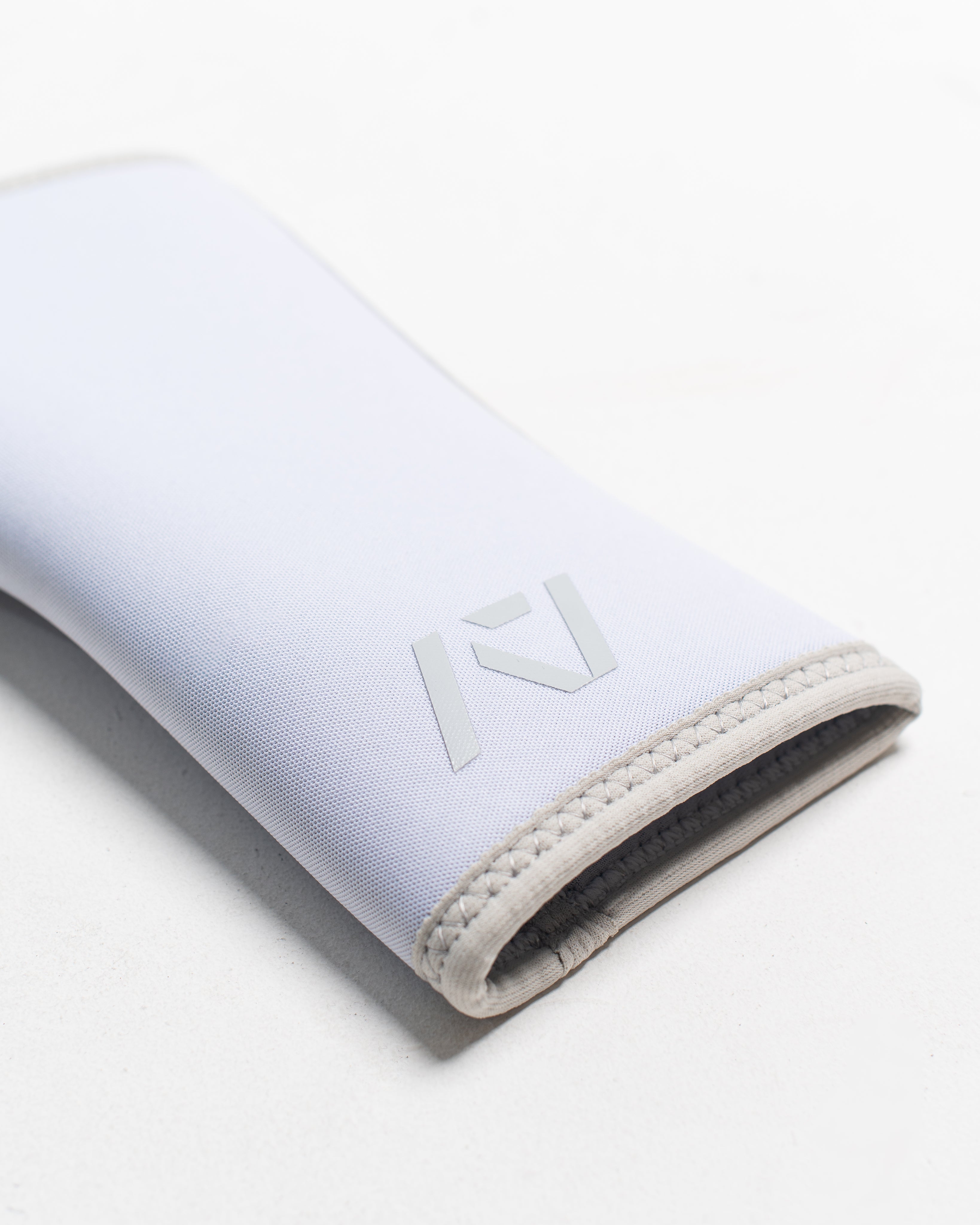 Close up of flatlay of stiff hourglass knee sleeve