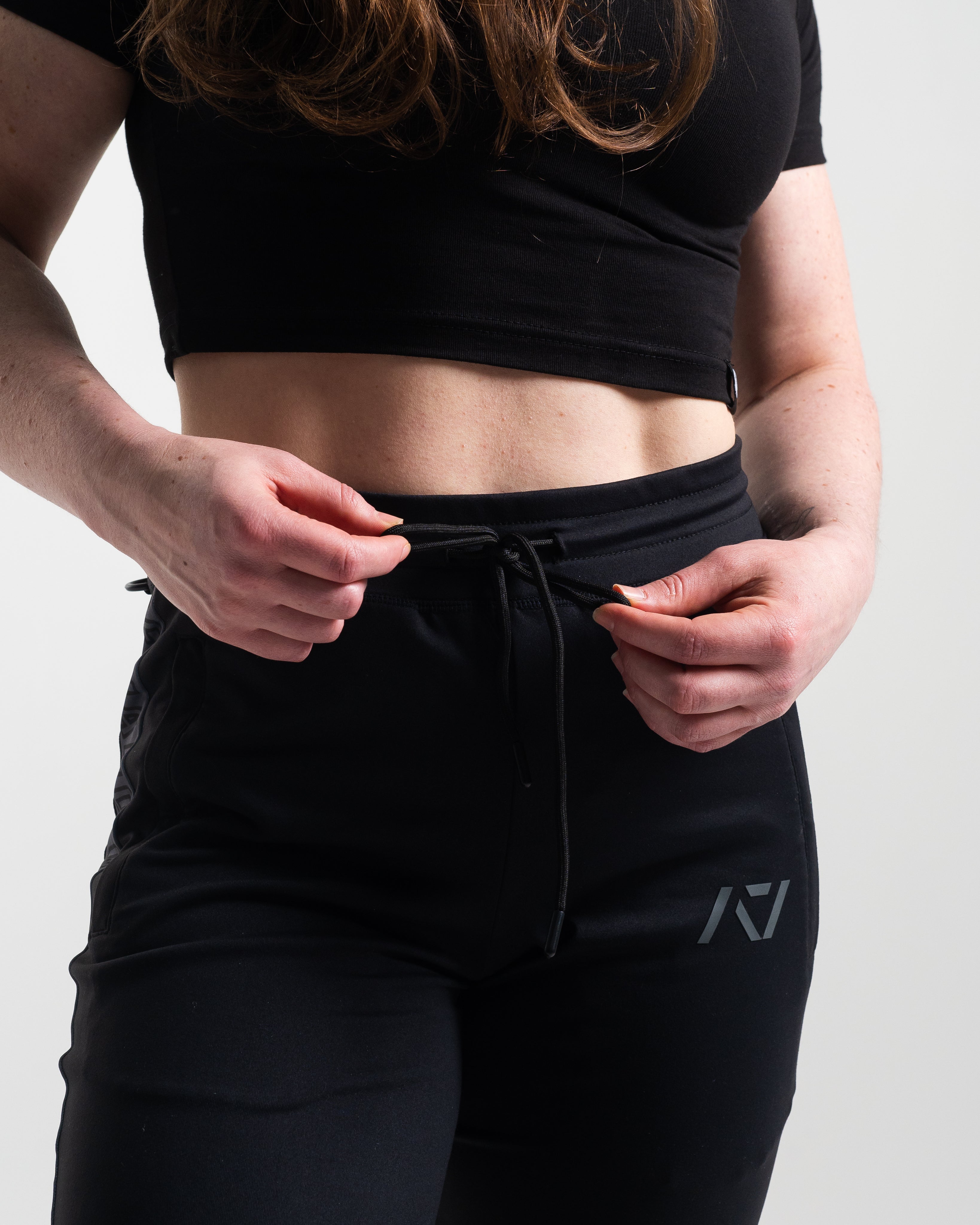 Drawstring for shadow stone defy joggers with shadow stone gray logo on left leg.