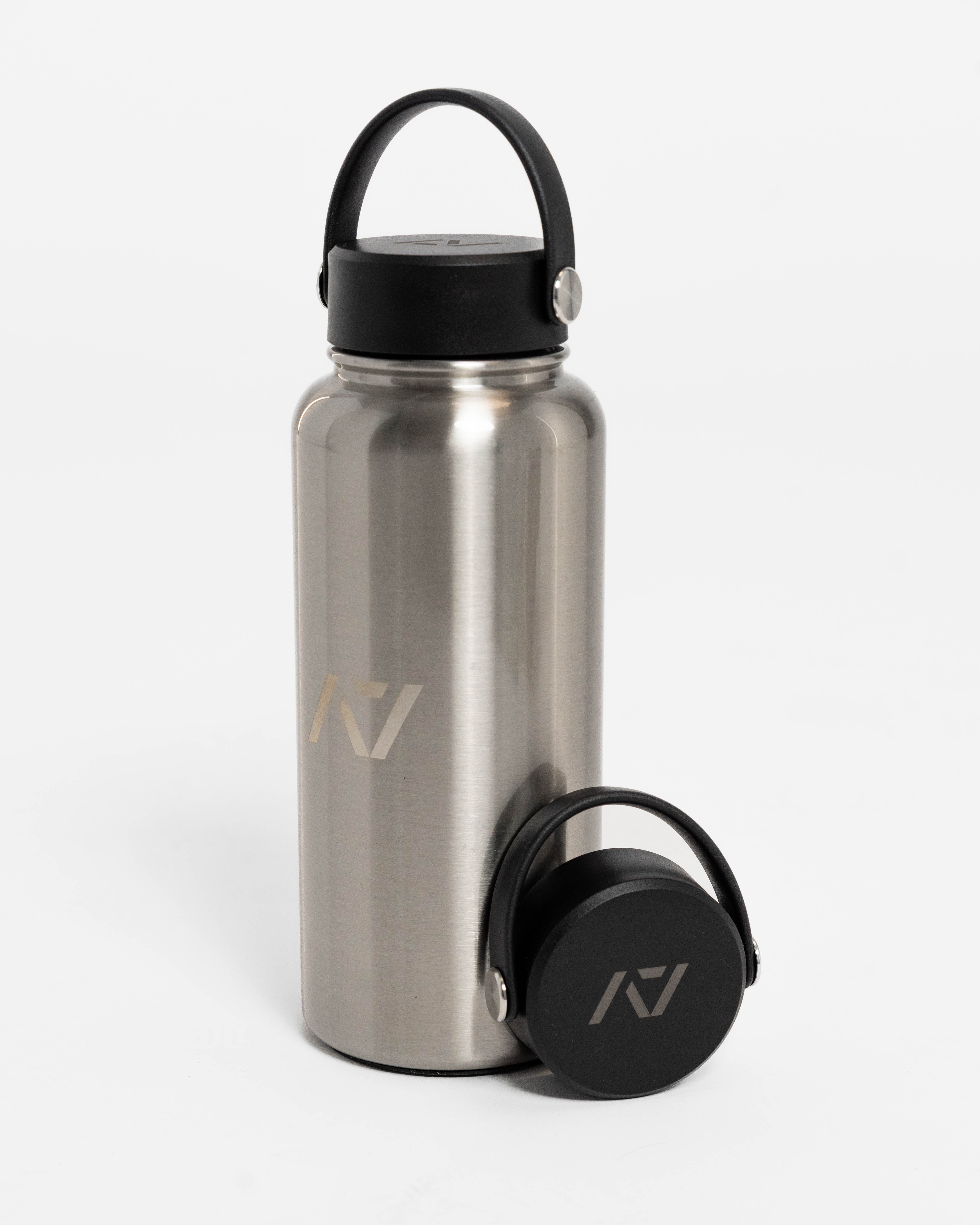 Stainless steel water bottle with black lid on a white background