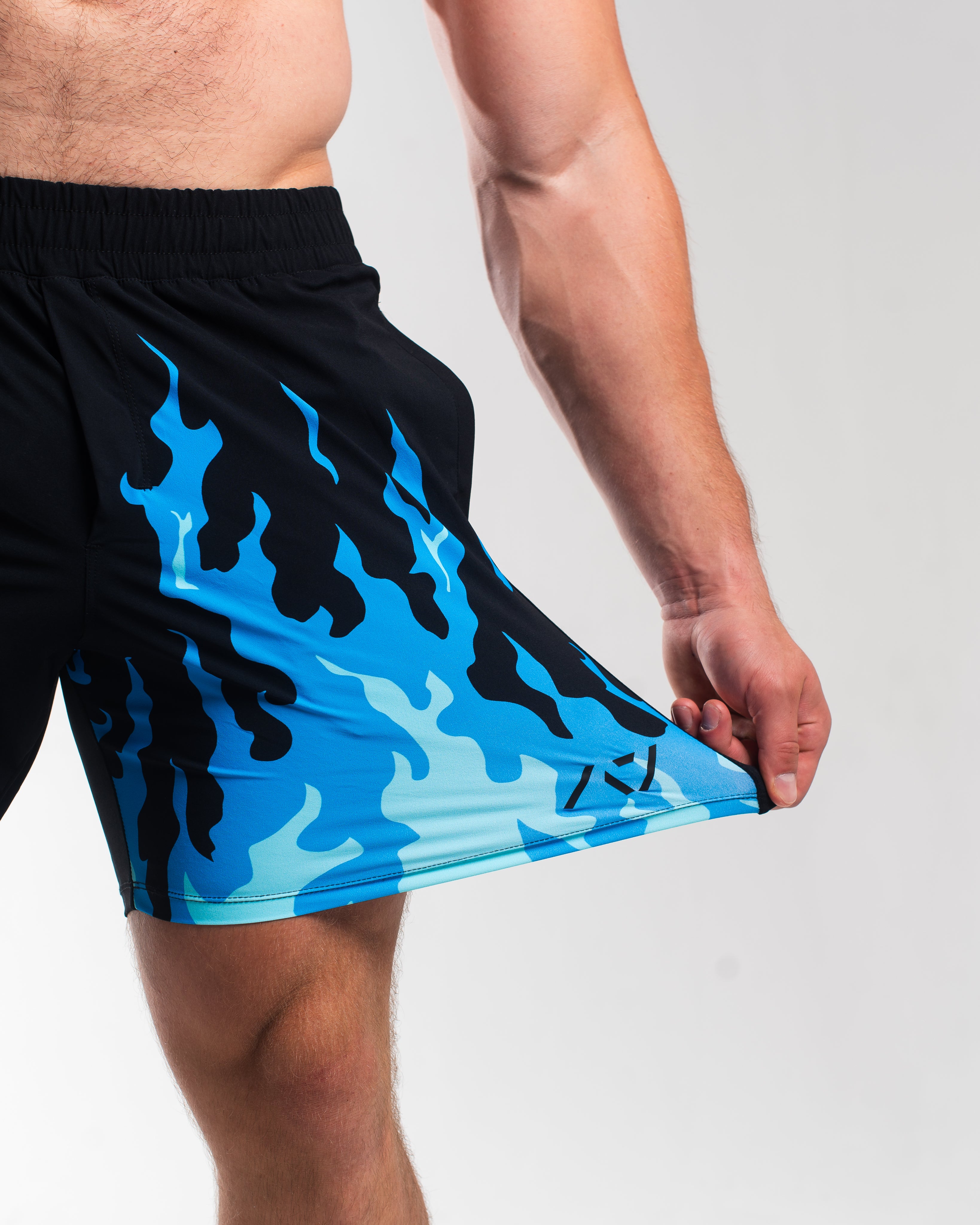 Demonstration of 360-degree stretch fabric on A7 Accelerant Blue shorts designed for total freedom of movement during training.