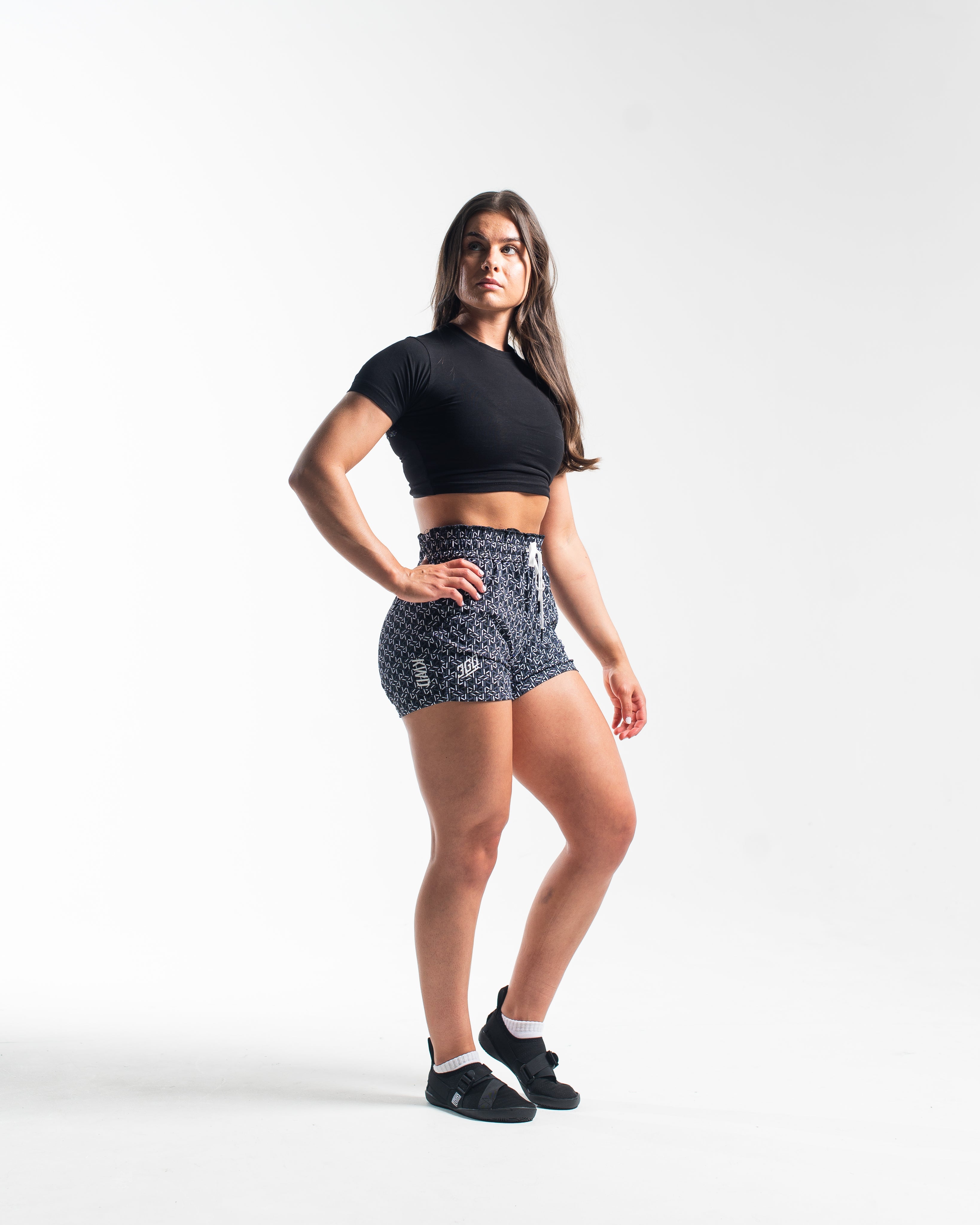 Full body view of athlete wearing A7 360Go KWD Shorts in Stelacrosha Black, showcasing premium fit and bold, all-black aesthetic.