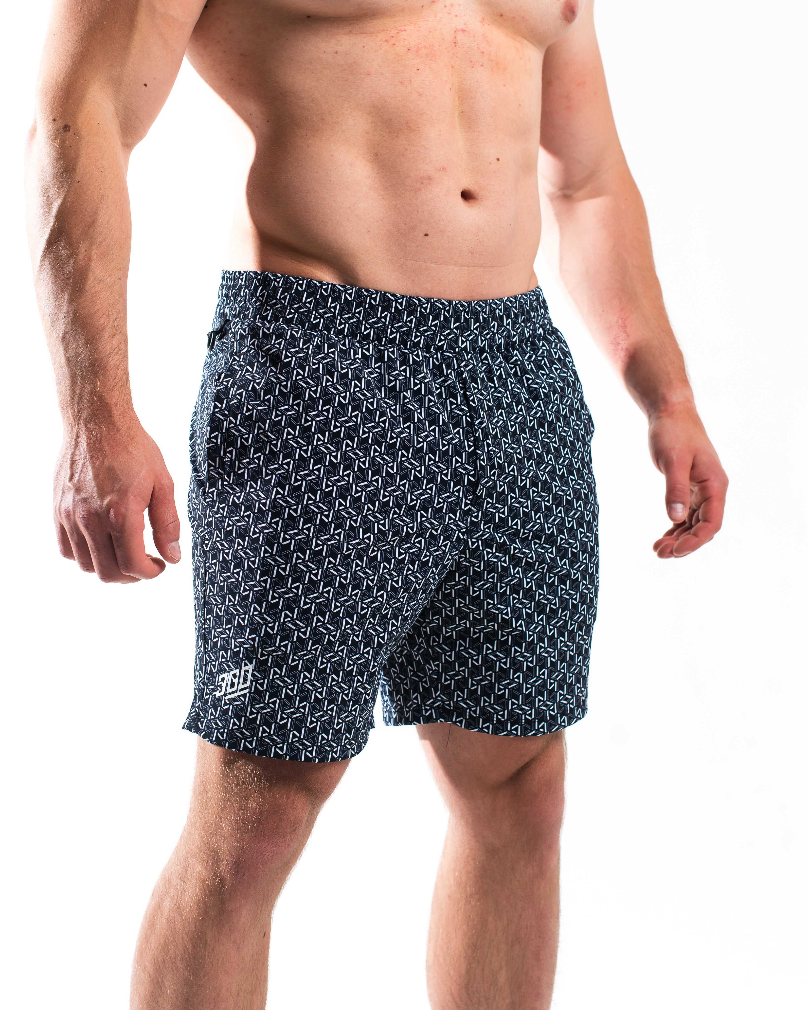 Front view of A7 360Go Shorts in Stelacrosha Black, Regular inseam, featuring textured black pattern and wide waistband.