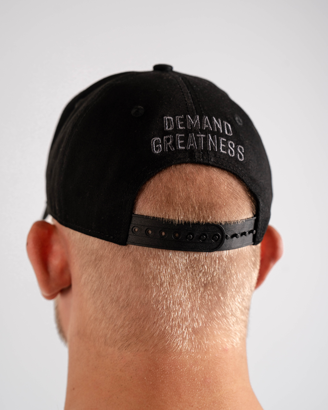 Rear view of 5 Panel Snapback Hat in Shadow Stone with adjustable snapback closure and breathable fabric. With Demand Greatness.