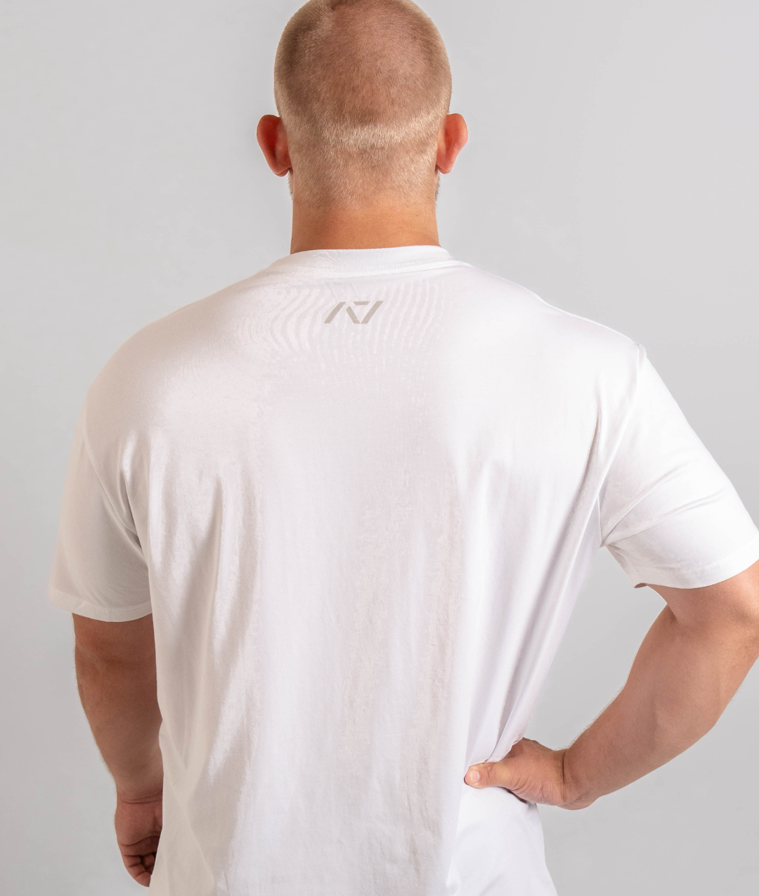 Back of white meet shirt with A7 logo on the upper center back to show underneath a singlet