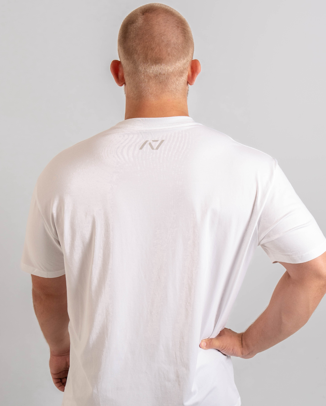 Back of white meet shirt with A7 logo on the upper center back to show underneath a singlet