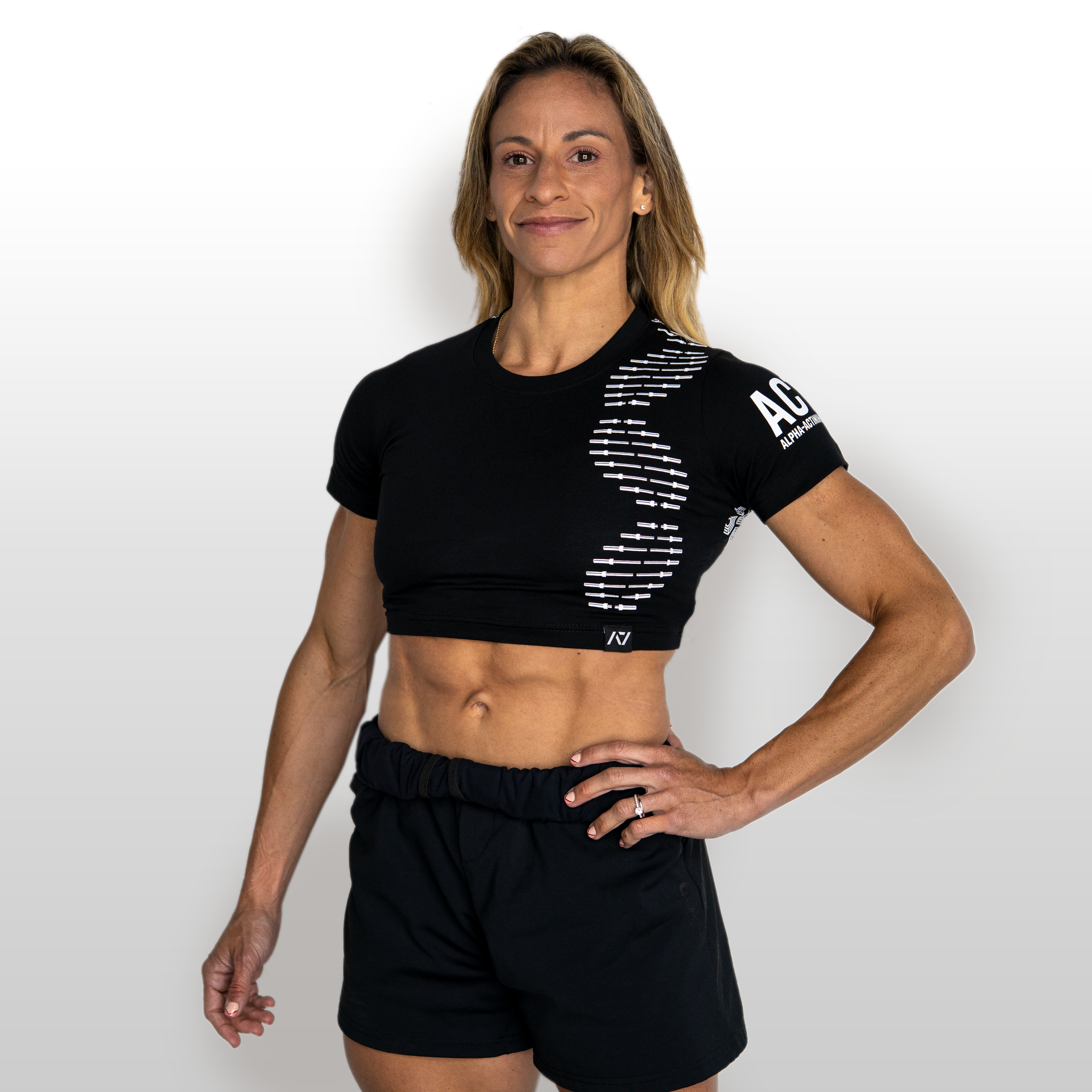 Woman wearing a black athletic outfit with branding on a white background
