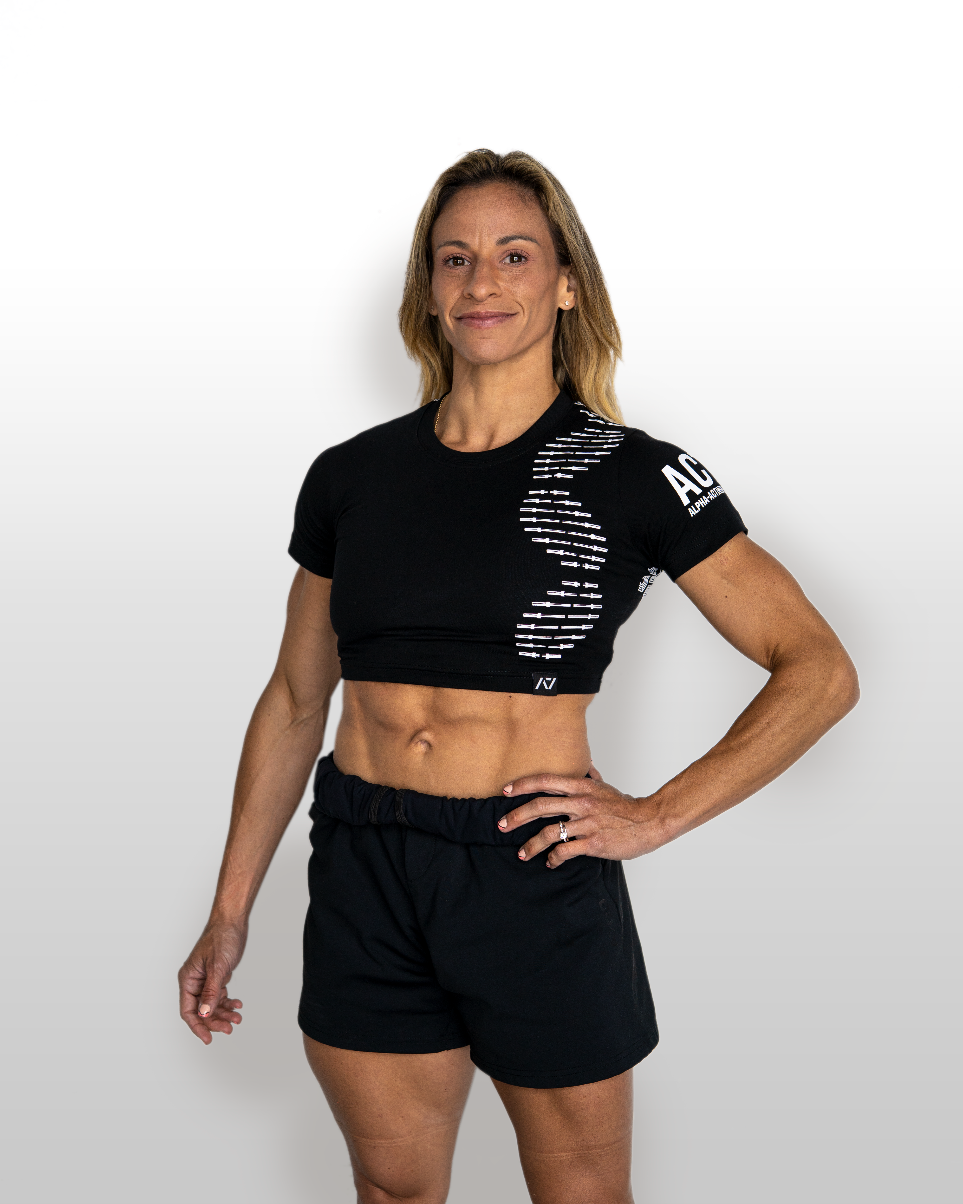 Woman wearing a black athletic outfit with branding on a white background