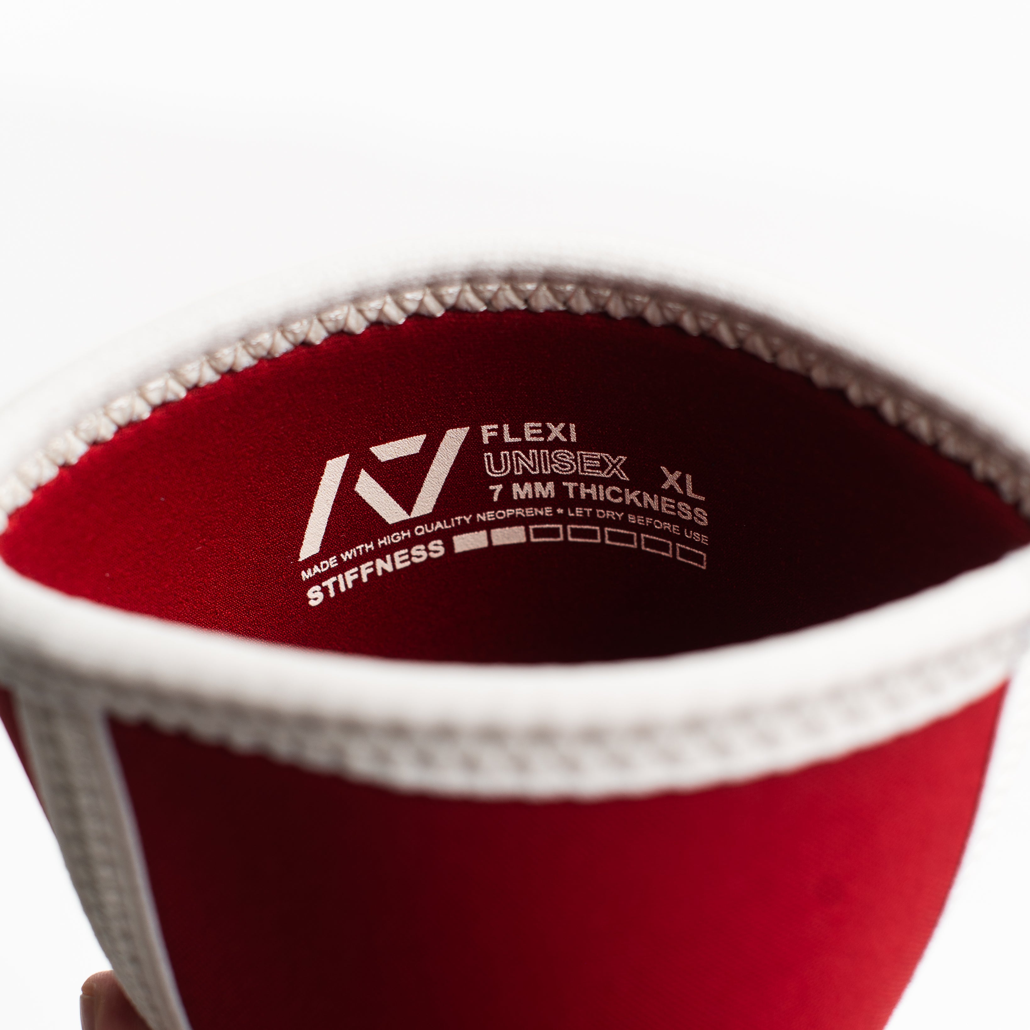 Red hourglass knee sleeve with branding and size details on a white background