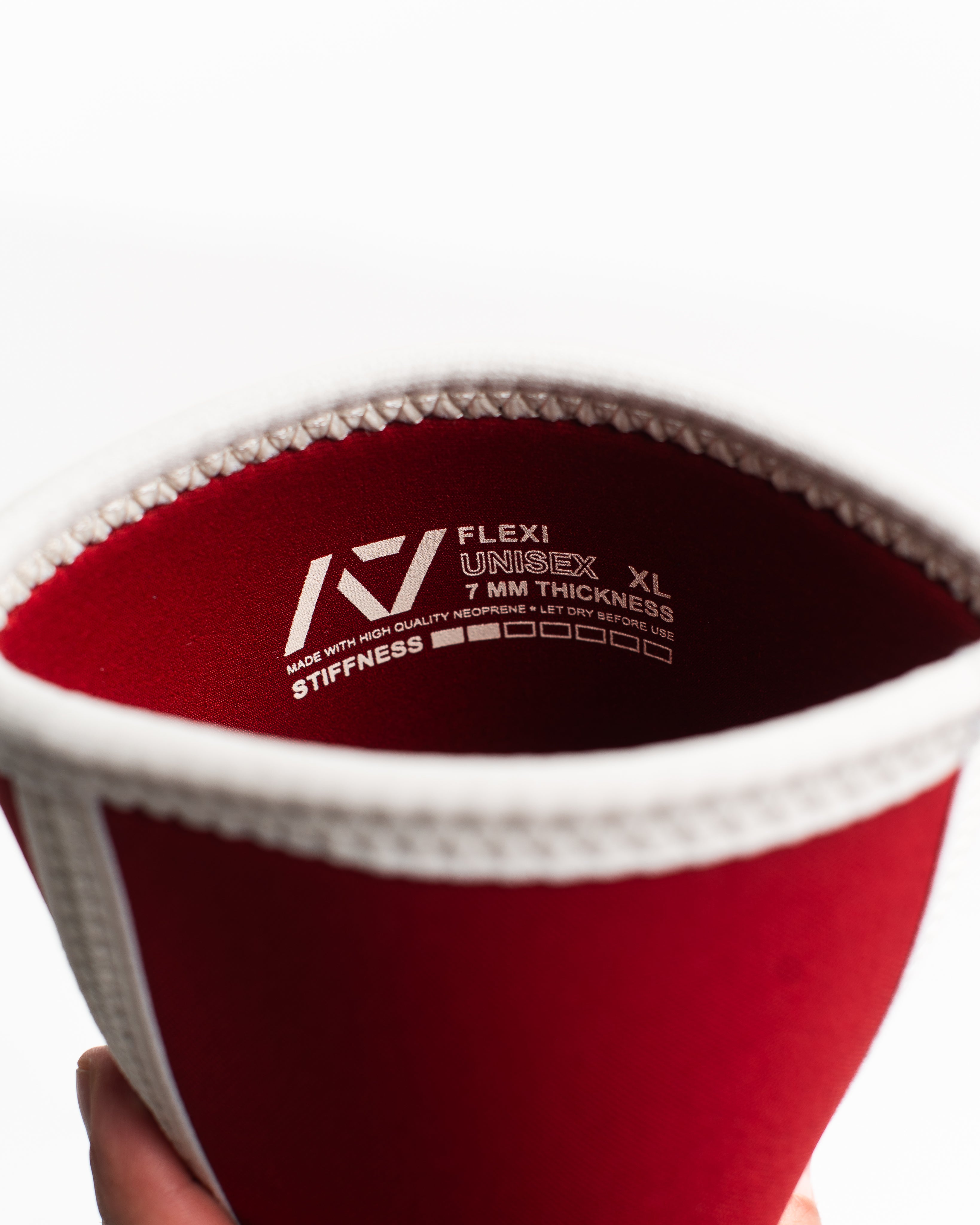 Red hourglass knee sleeve with branding and size details on a white background