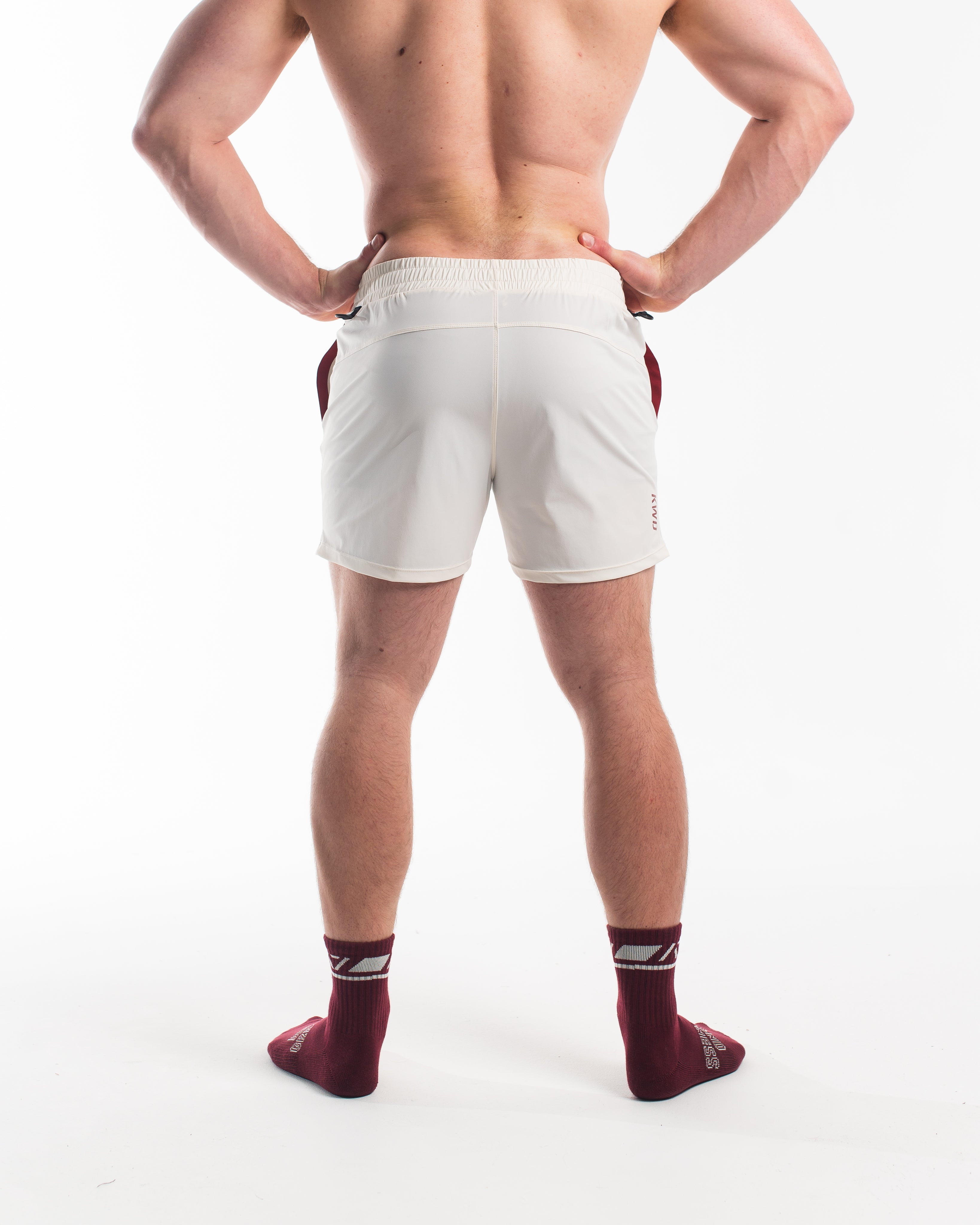 Back shot showcasing the back seams of the shorts and the red accents of the pockets with the key clips.