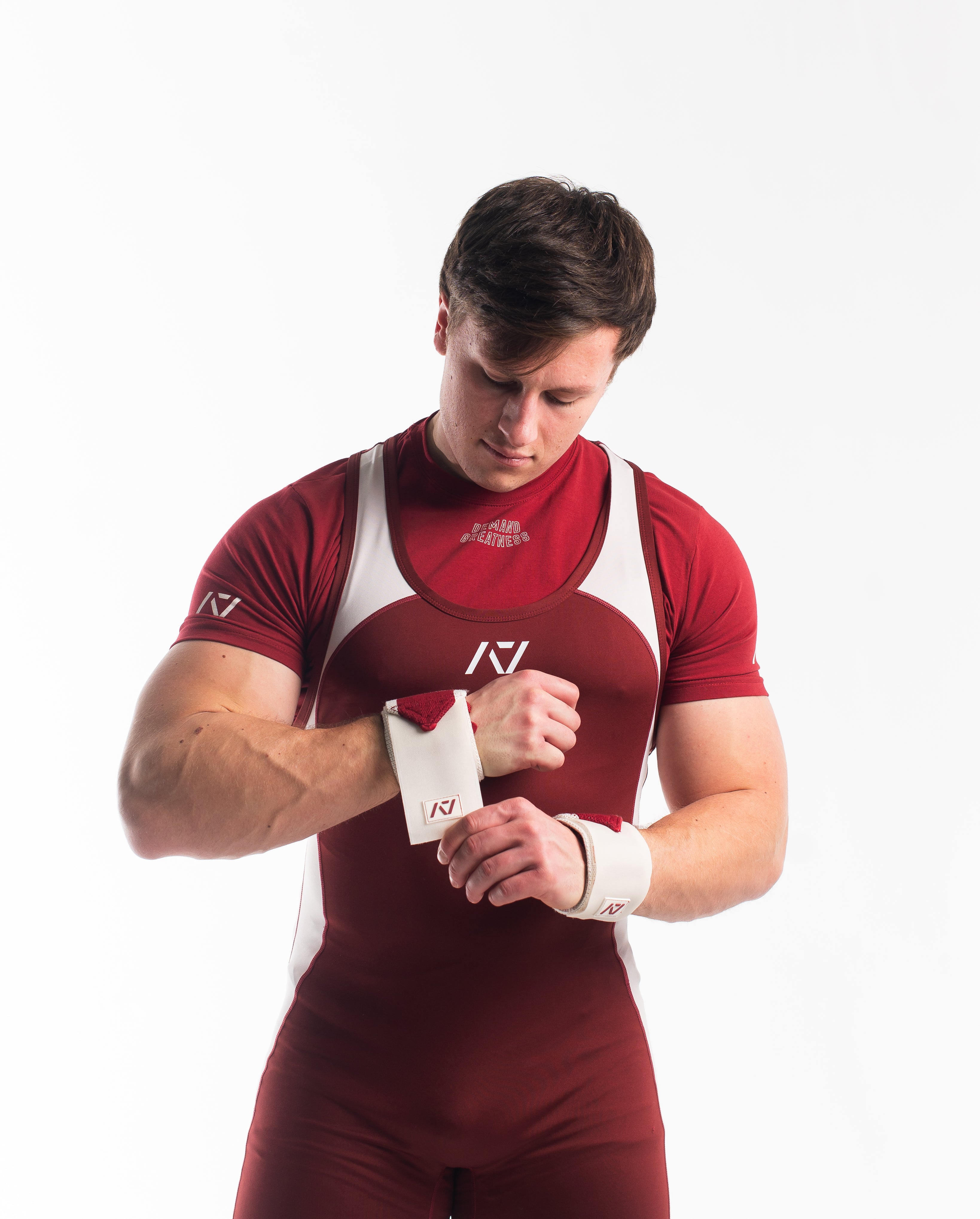 Male model in Ivory Rose Meet Kit putting on the Ivory Rose wrist wraps