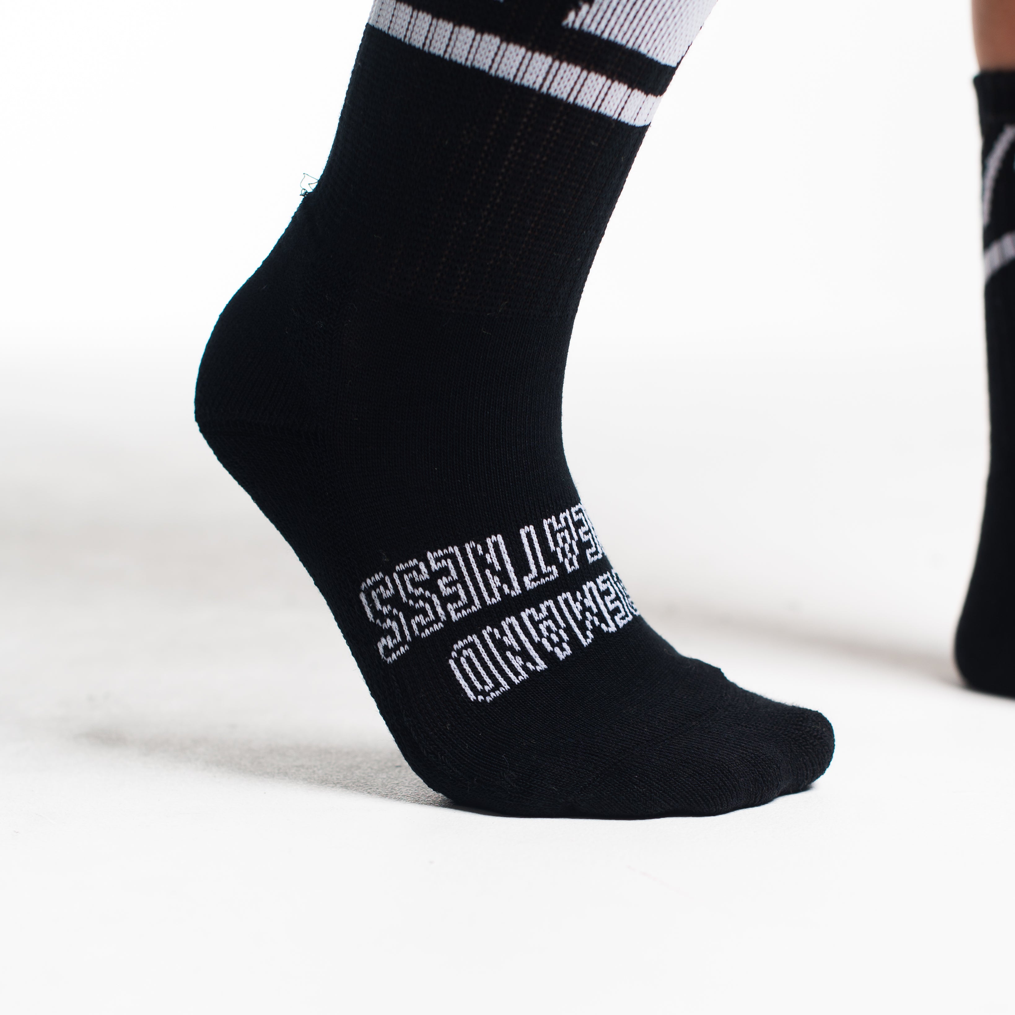 Close-up of the knit fabric on A7 Crew Socks in Black Domino, showing texture and stitching details.