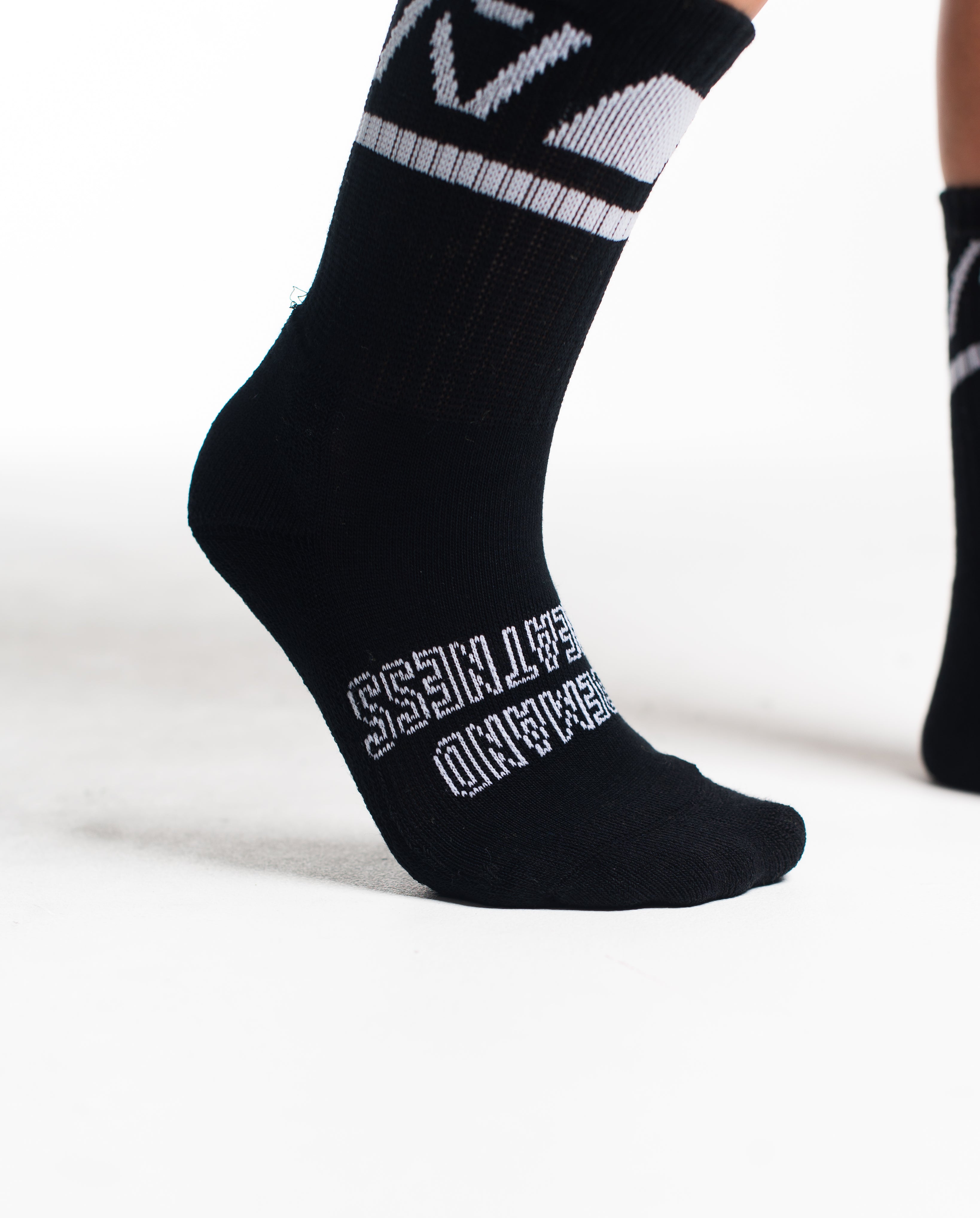 Close-up of the knit fabric on A7 Crew Socks in Black Domino, showing texture and stitching details.