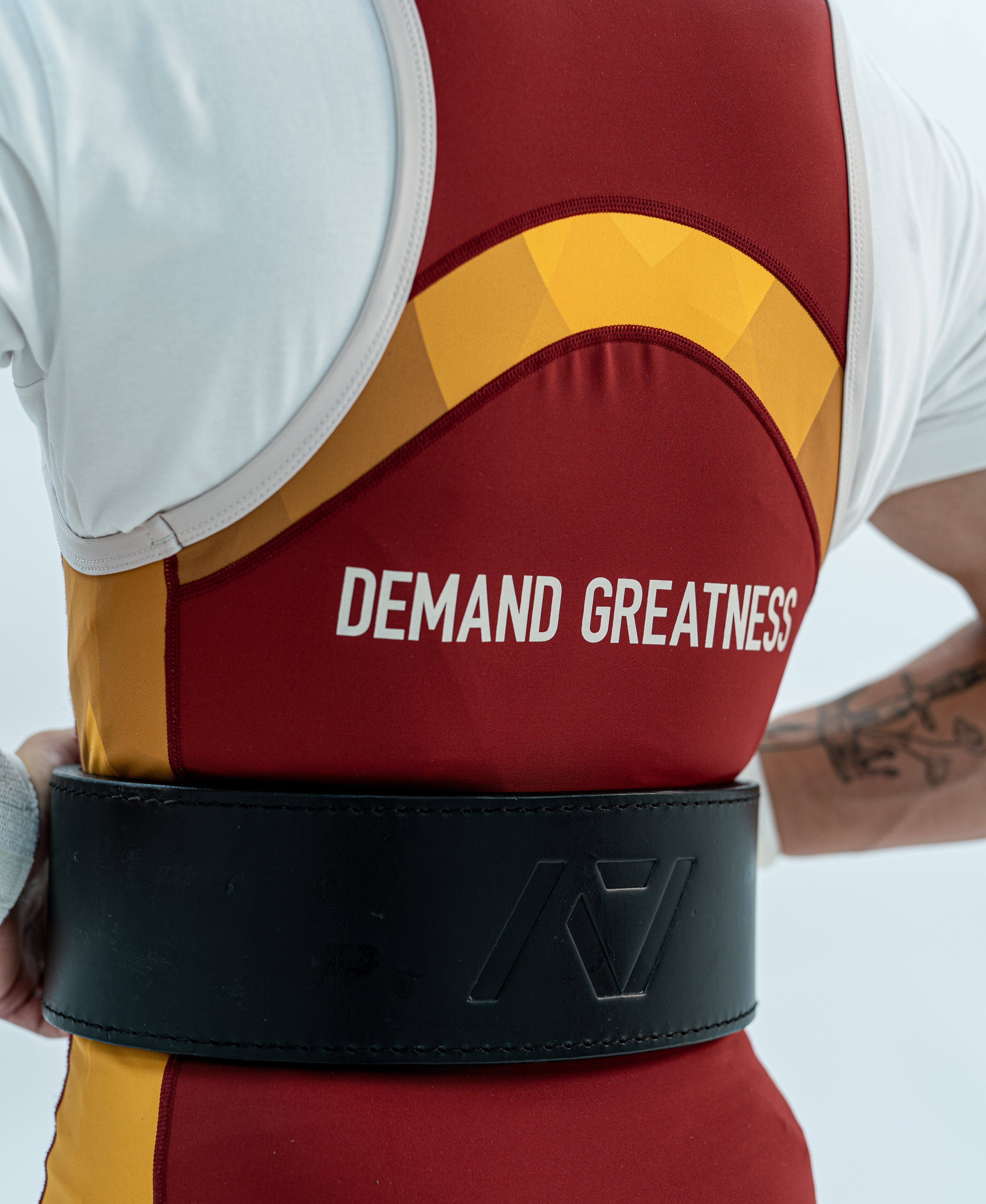 Close up of the back DEMAND GREATNESS lettering and cut of the rausch singlet