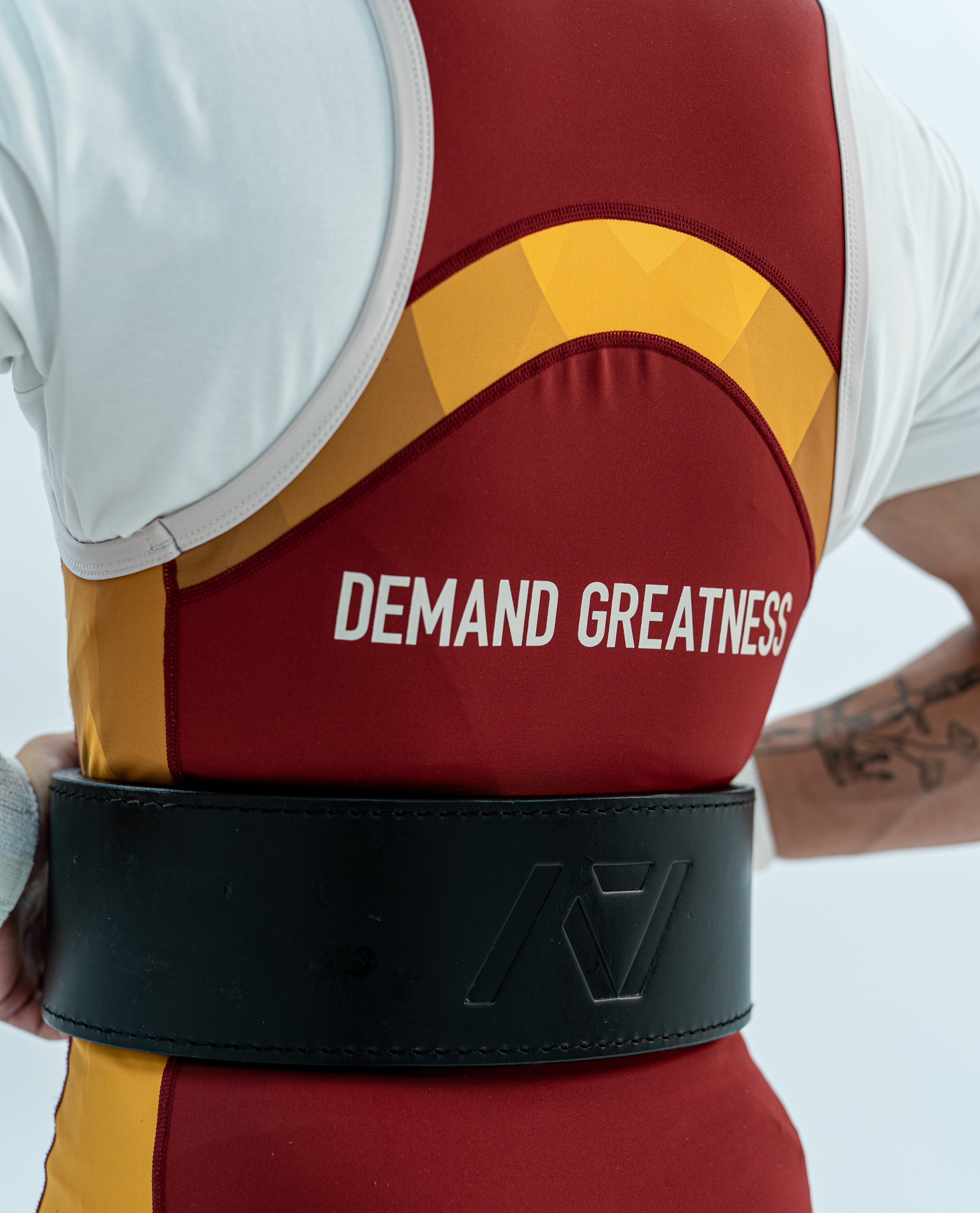 Close up of the back DEMAND GREATNESS lettering and cut of the rausch singlet