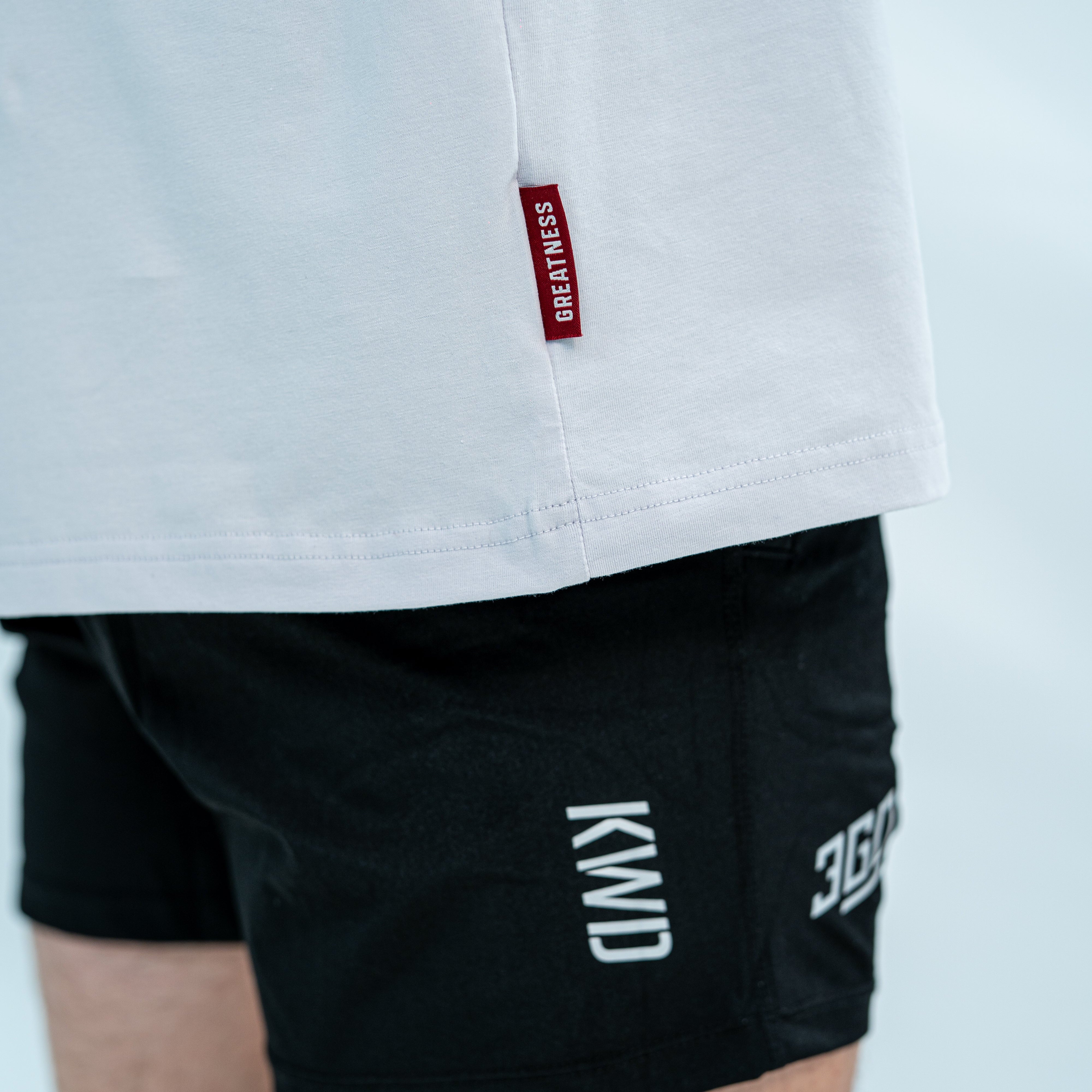 Showcasing the red hem tag of over-fit bloom shirt on male model