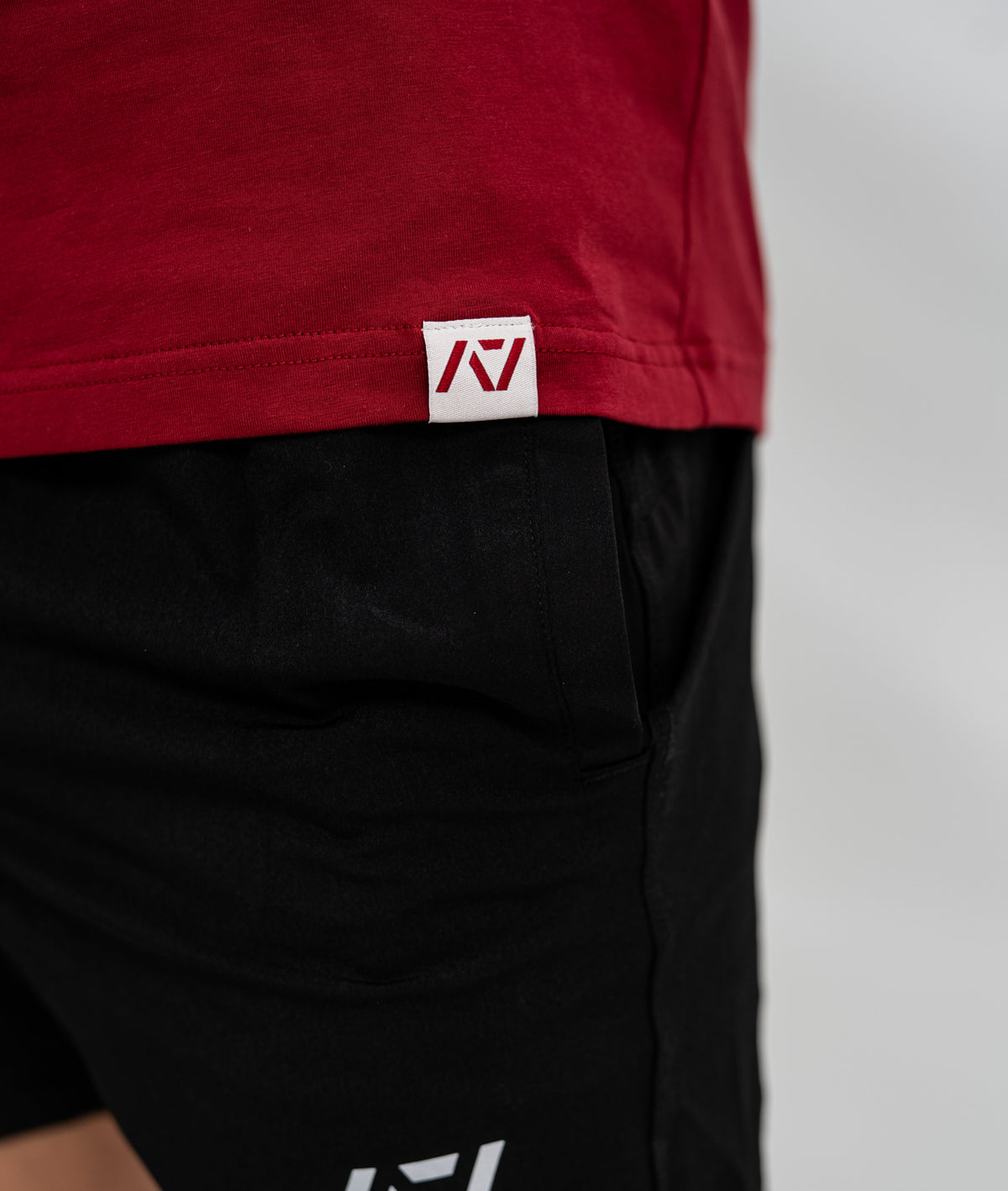 Red Bar Grip Shirt with a logo on a plain background