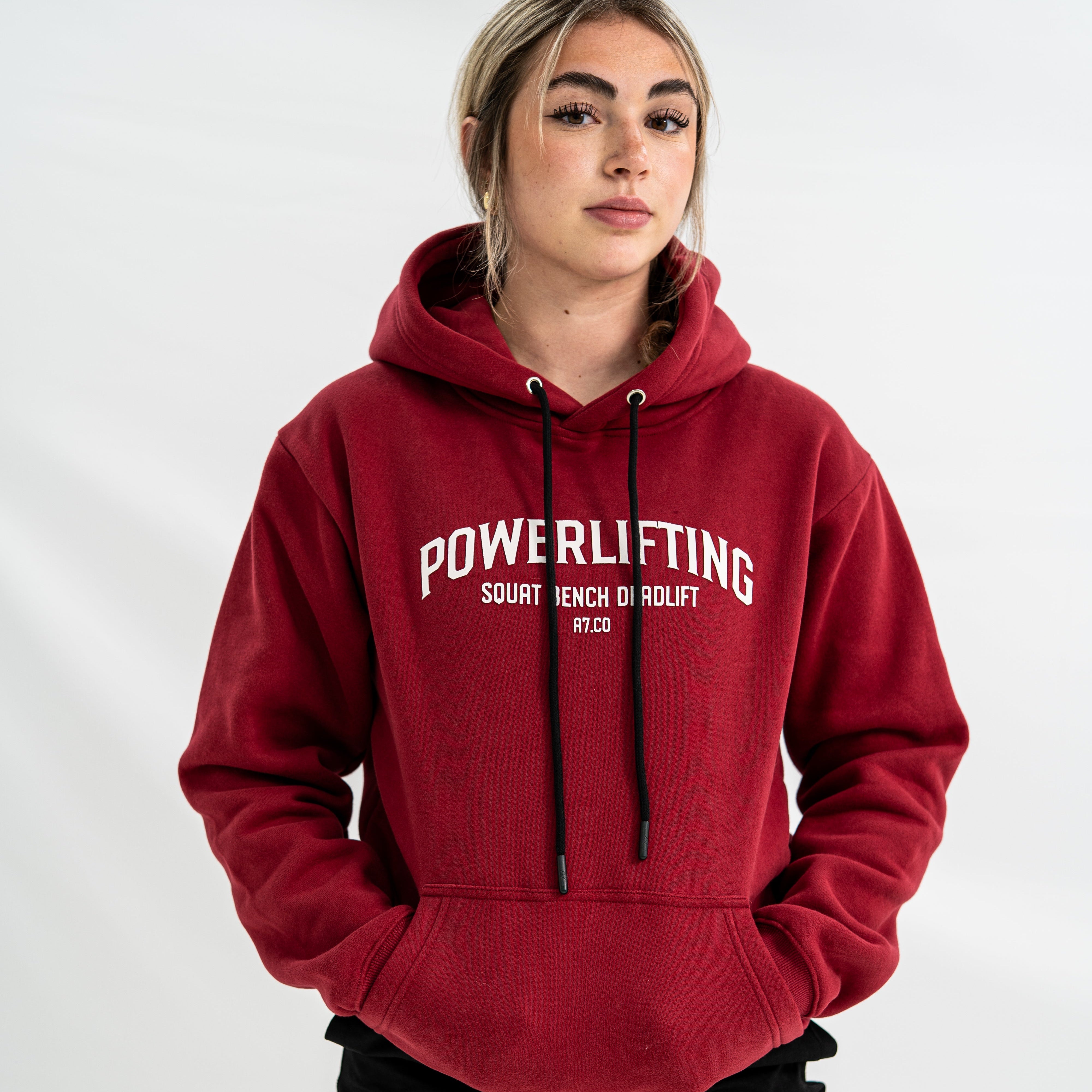 Female wearing a red 'Powerlifting' Bar Grip hoodie on a white background