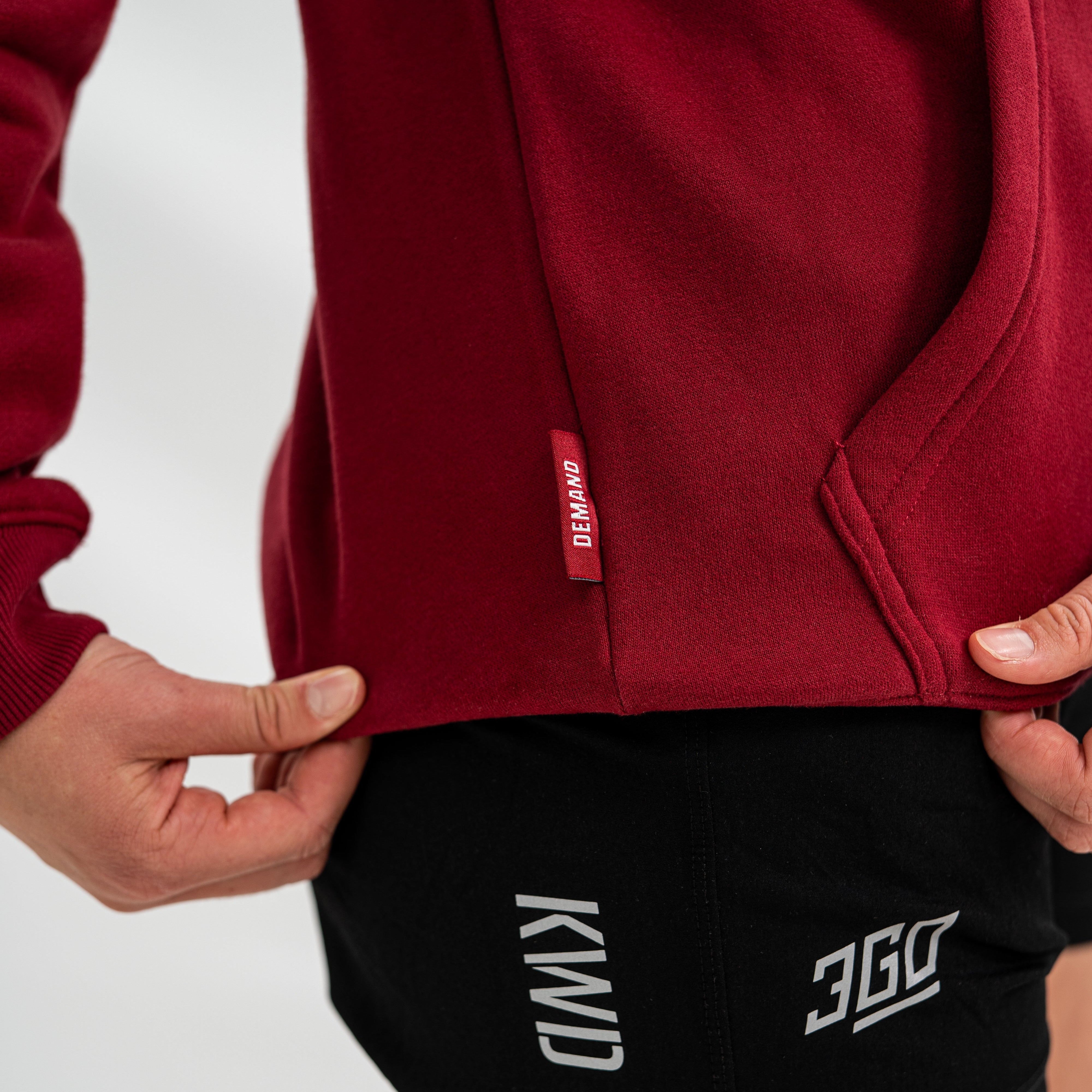 Red Bar Grip hoodie with a brand logo and black shorts with visible branding on a white background
