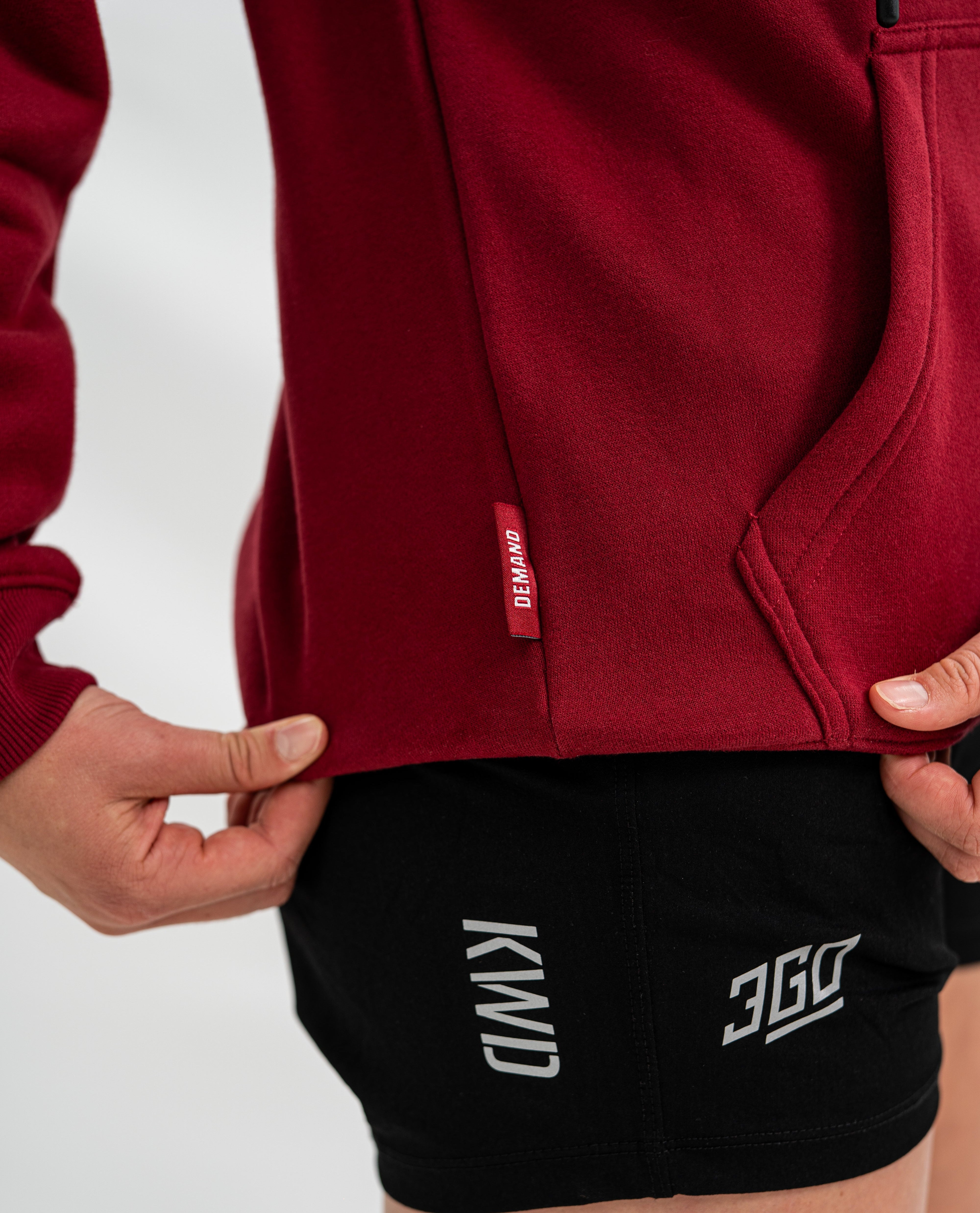 Red Bar Grip hoodie with a brand logo and black shorts with visible branding on a white background