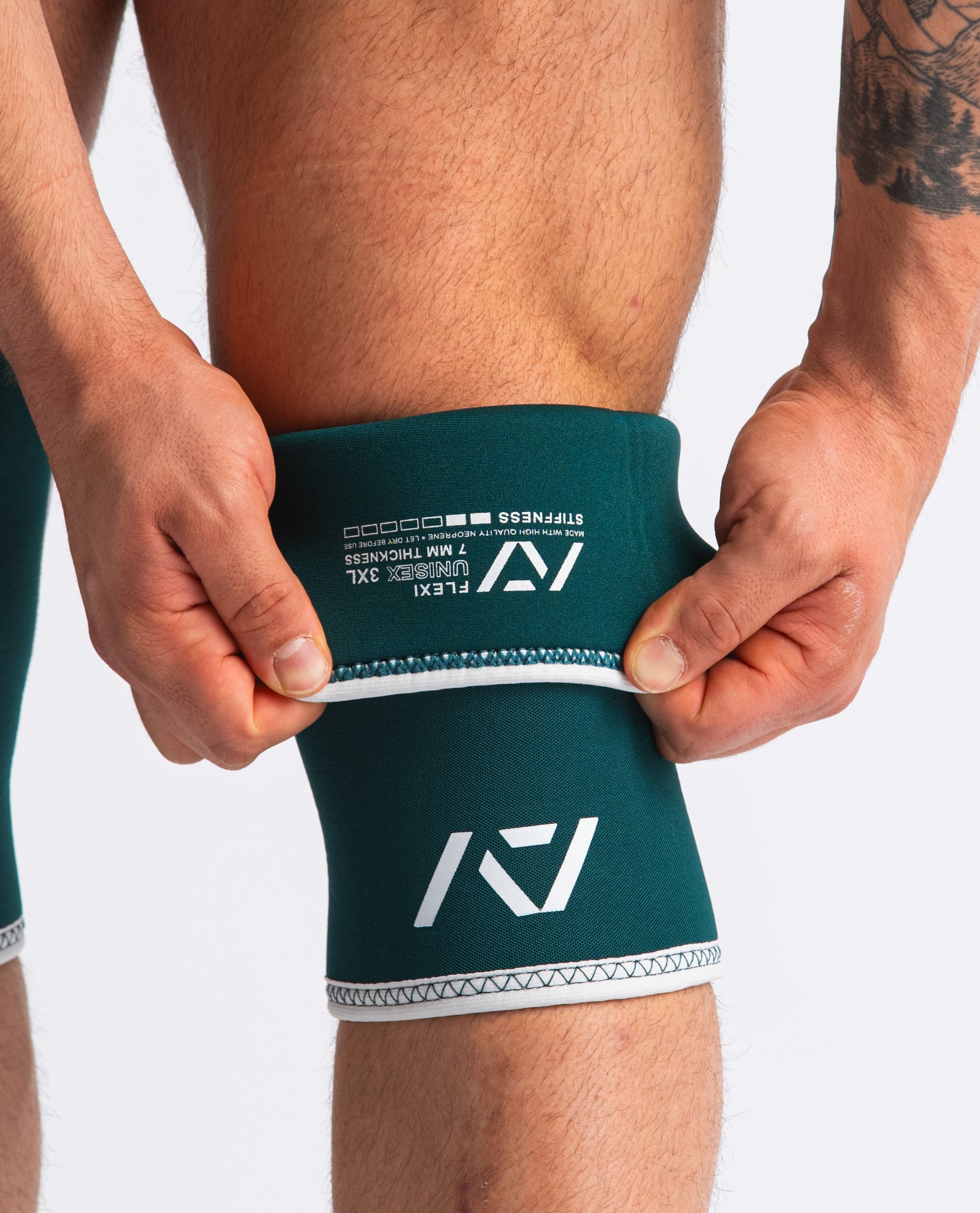 Close up of Hourglass Knee Sleeves - Flexi - Emerald folded showing label and double-stitched seams.