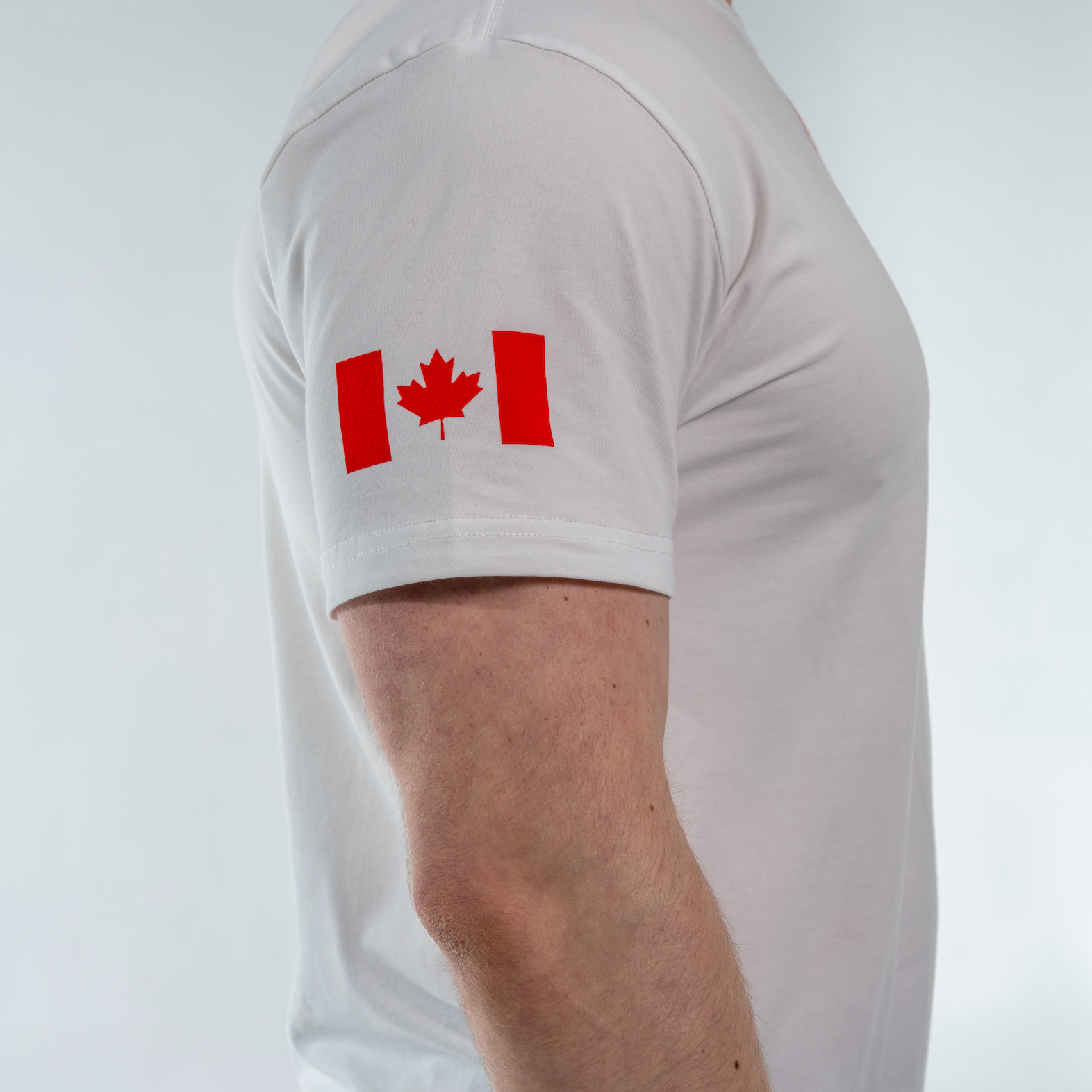White t-shirt with a red Canadian flag design on a plain background
