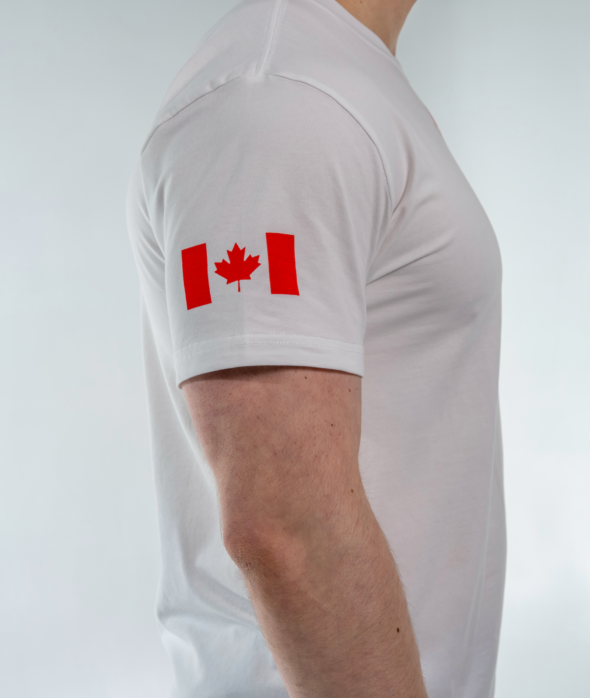 White t-shirt with a red Canadian flag design on a plain background