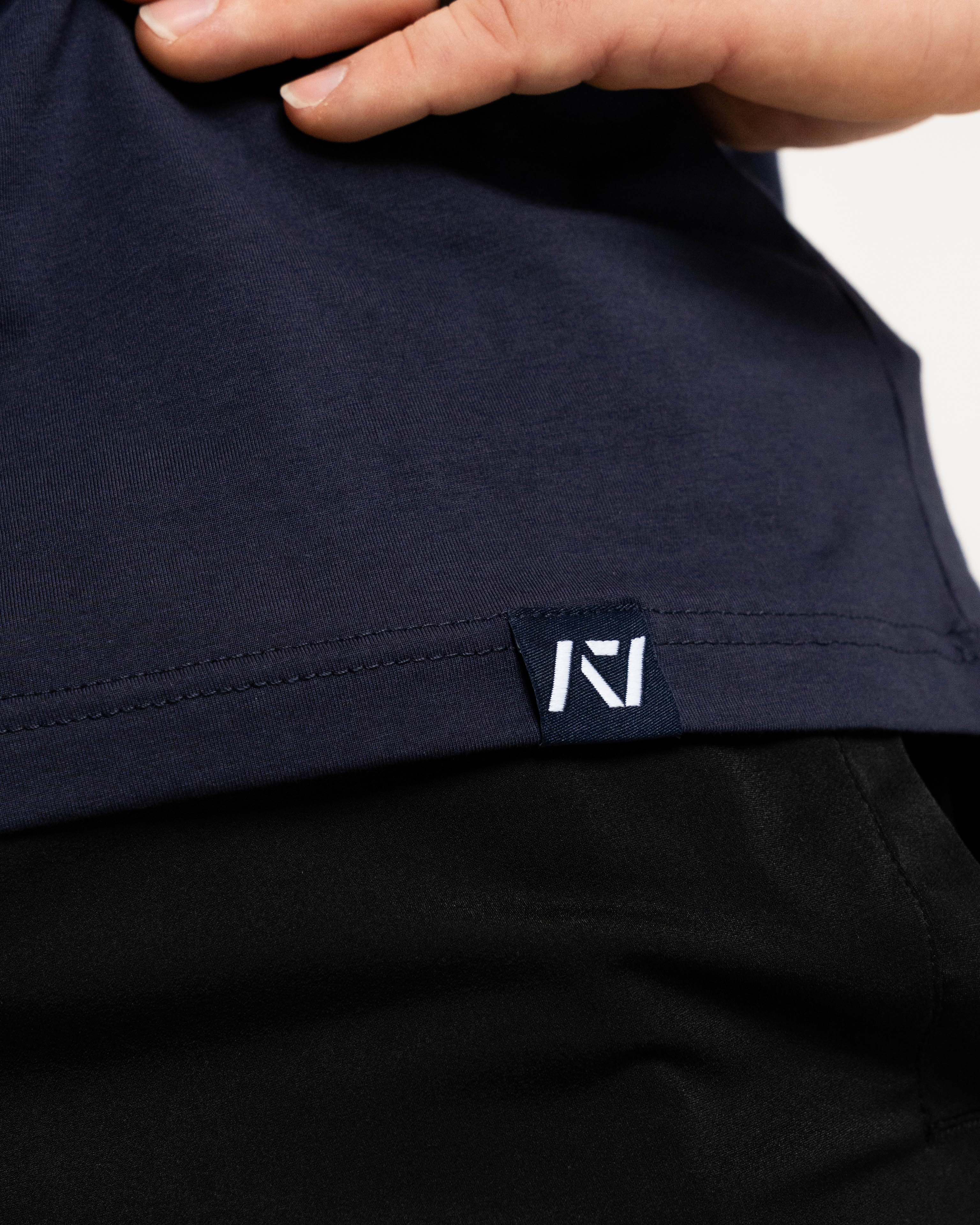 Close up of hem tag with a7 logo on NSTP mens bar grip shirt
