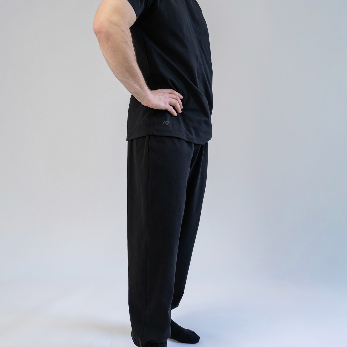 Person wearing a black outfit on a white background