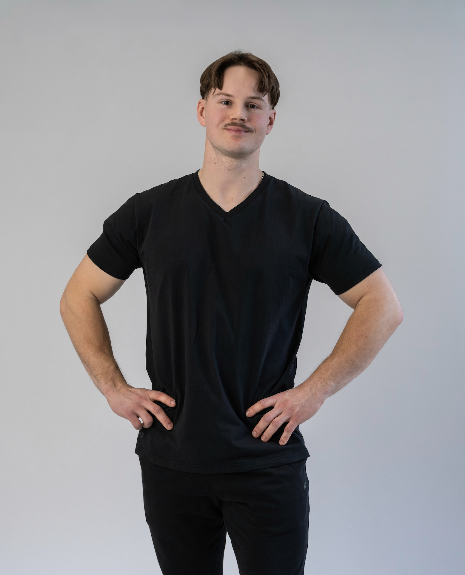 Man wearing a black t-shirt against a plain background