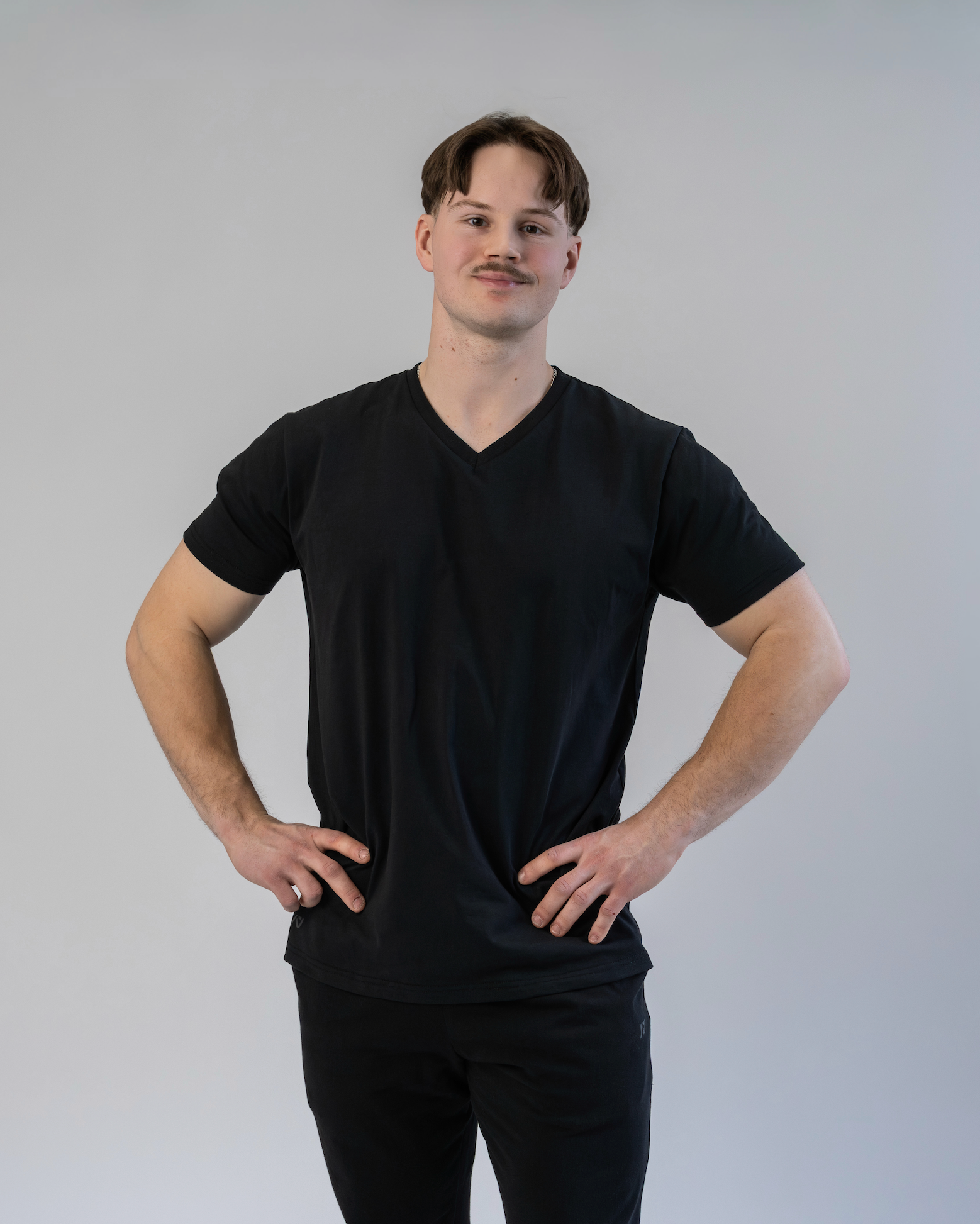 Man wearing a black t-shirt against a plain background