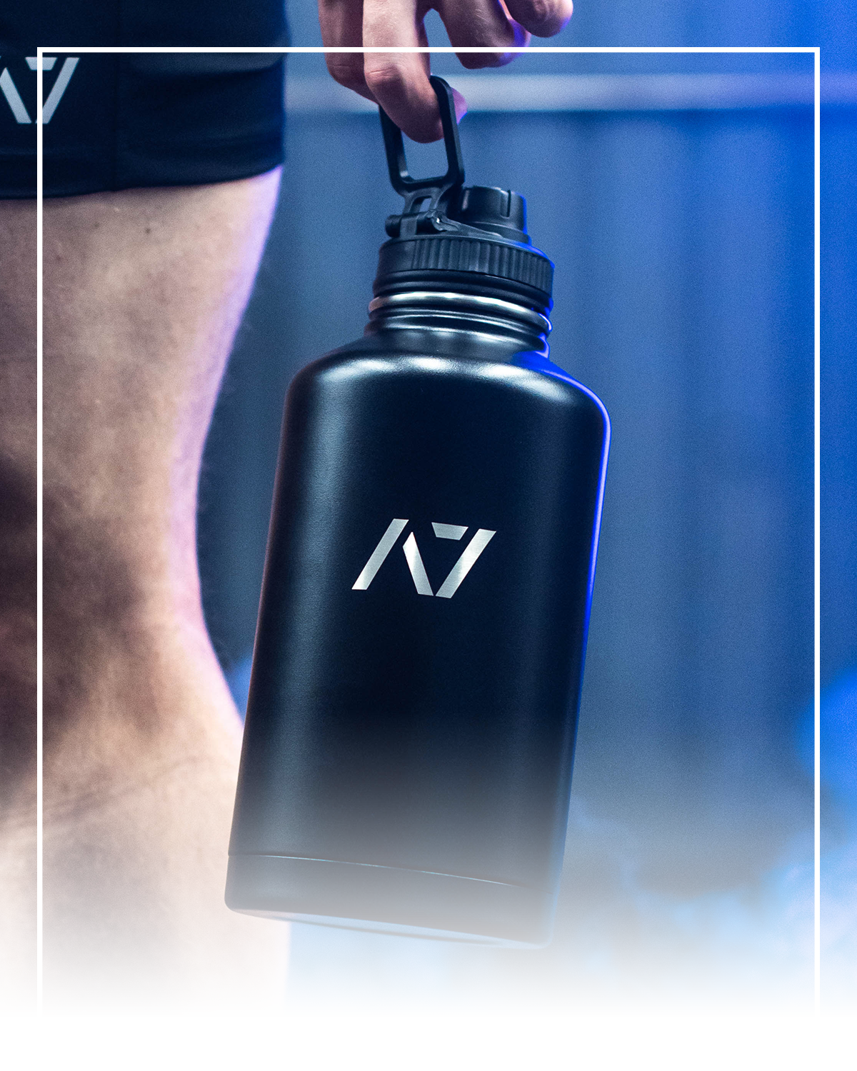 Black water bottle with a logo held by a person against a blue gradient background