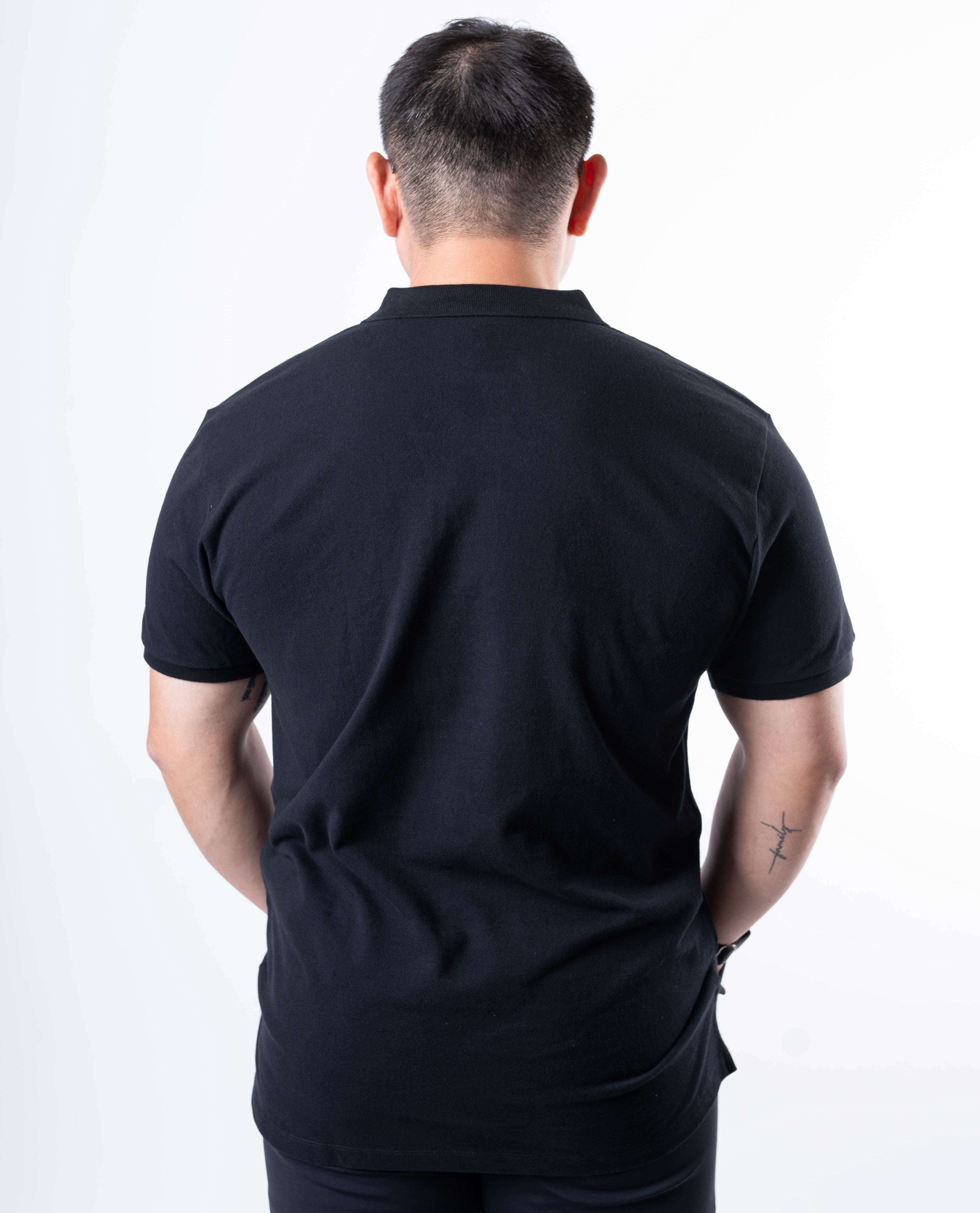 Back view of A7 Cotton Polo in Black, highlighting the tennis tail design.