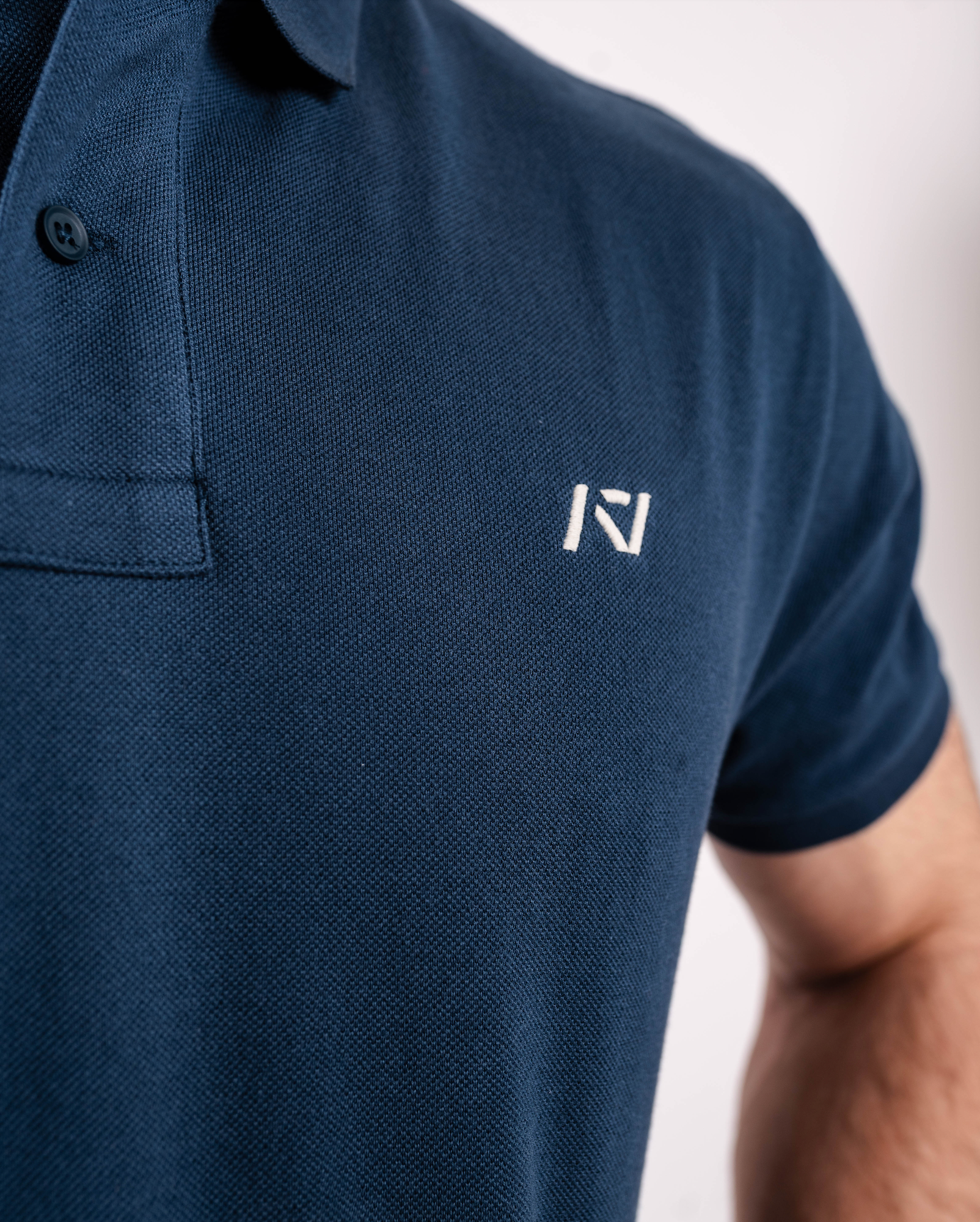 Close-up of the soft cotton fabric of the A7 Cotton Polo in Tides Blue.