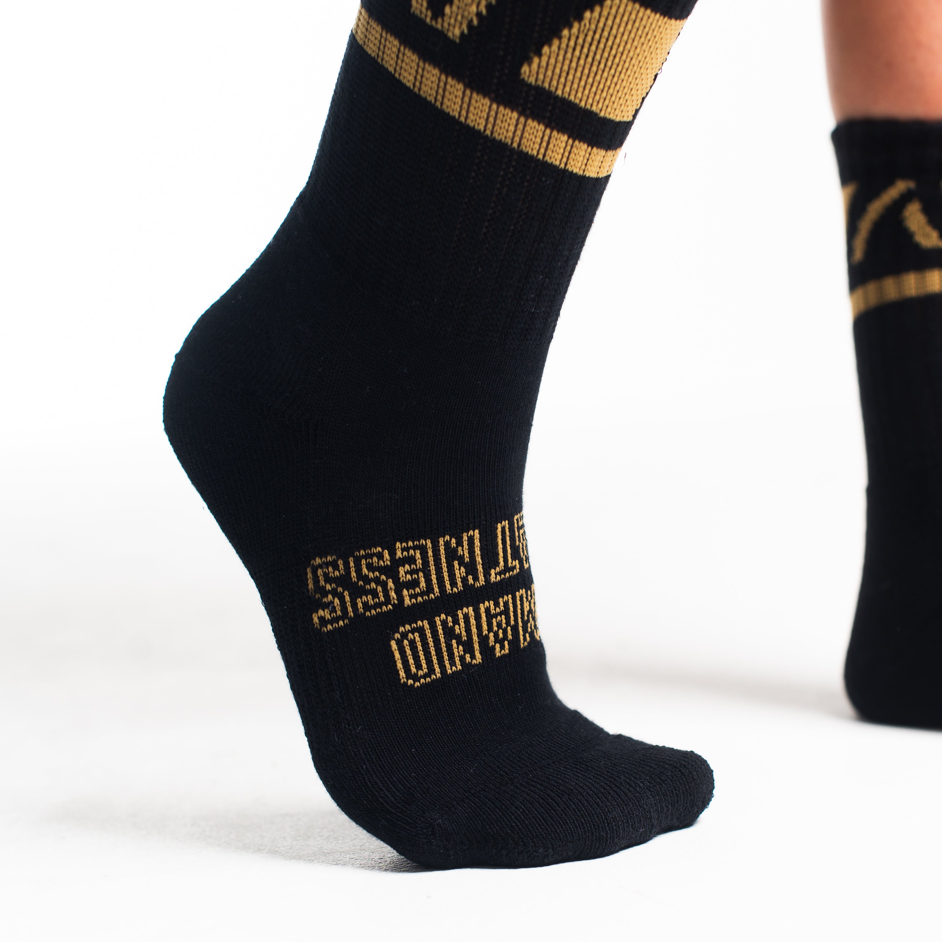 Close-up of the knit fabric on A7 Crew Socks in Gold Standard, showing texture and stitching details.