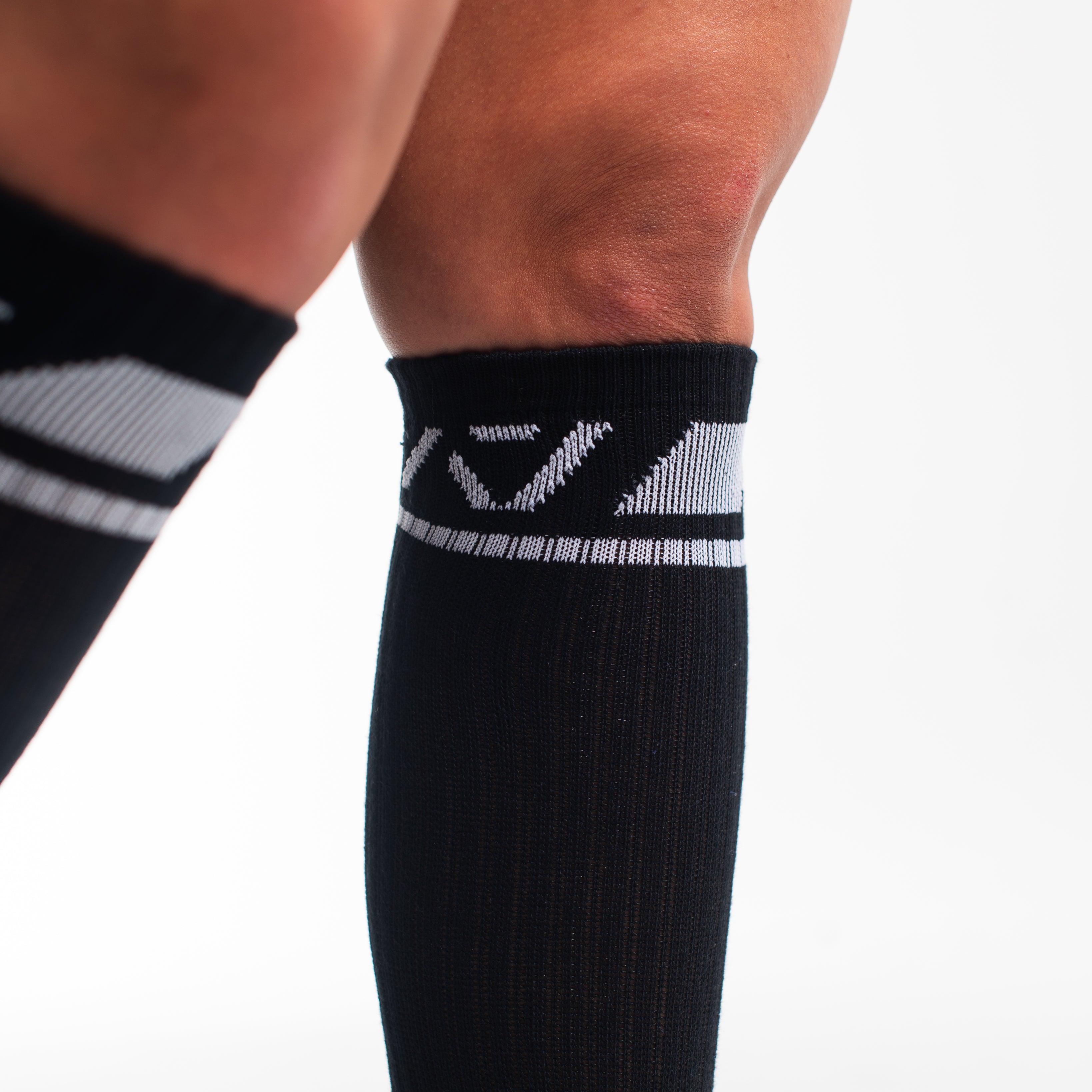 Close-up of the knit fabric on A7 Deadlift Socks in Domino Black, showing texture and stitching details.