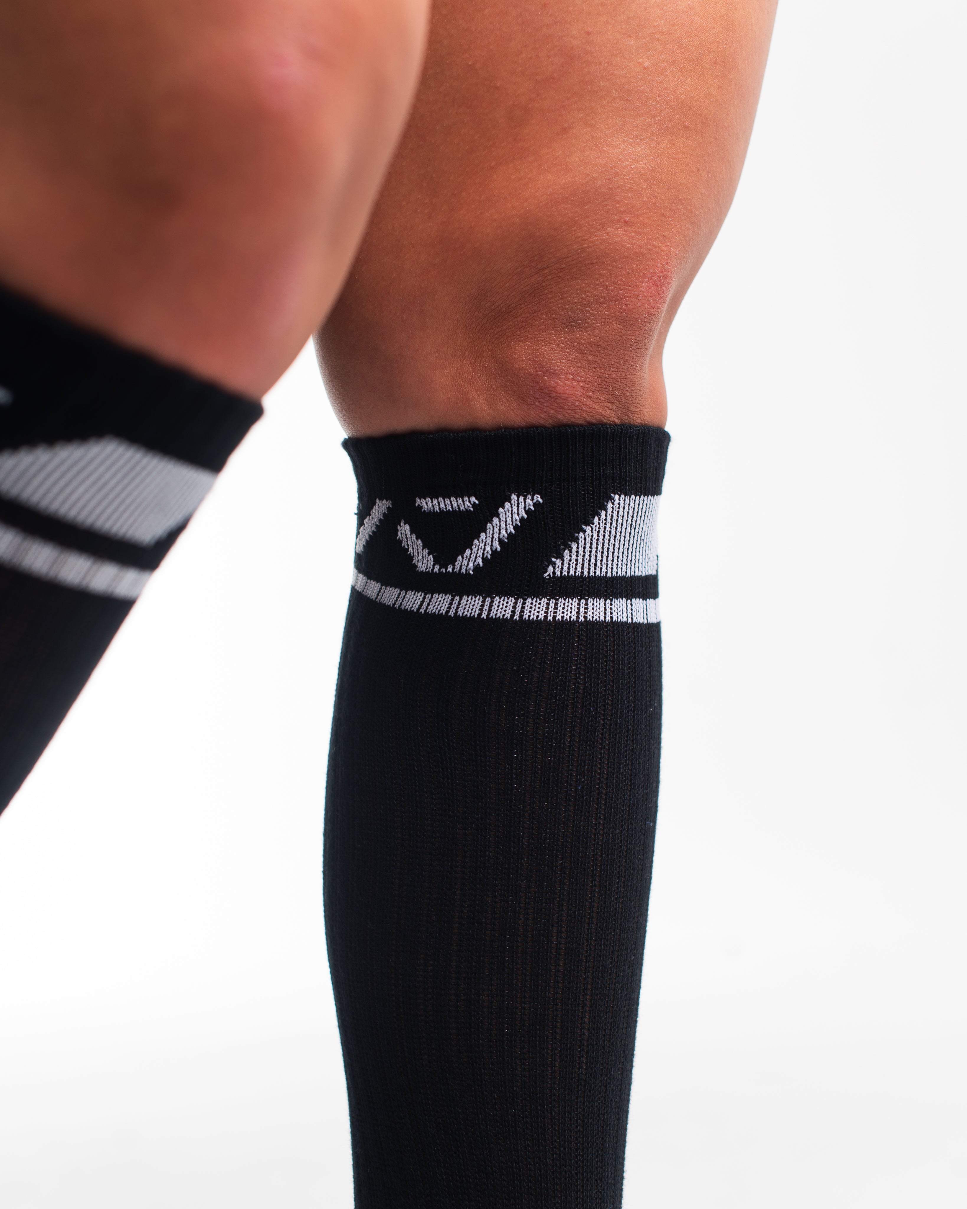 Close-up of the knit fabric on A7 Deadlift Socks in Domino Black, showing texture and stitching details.