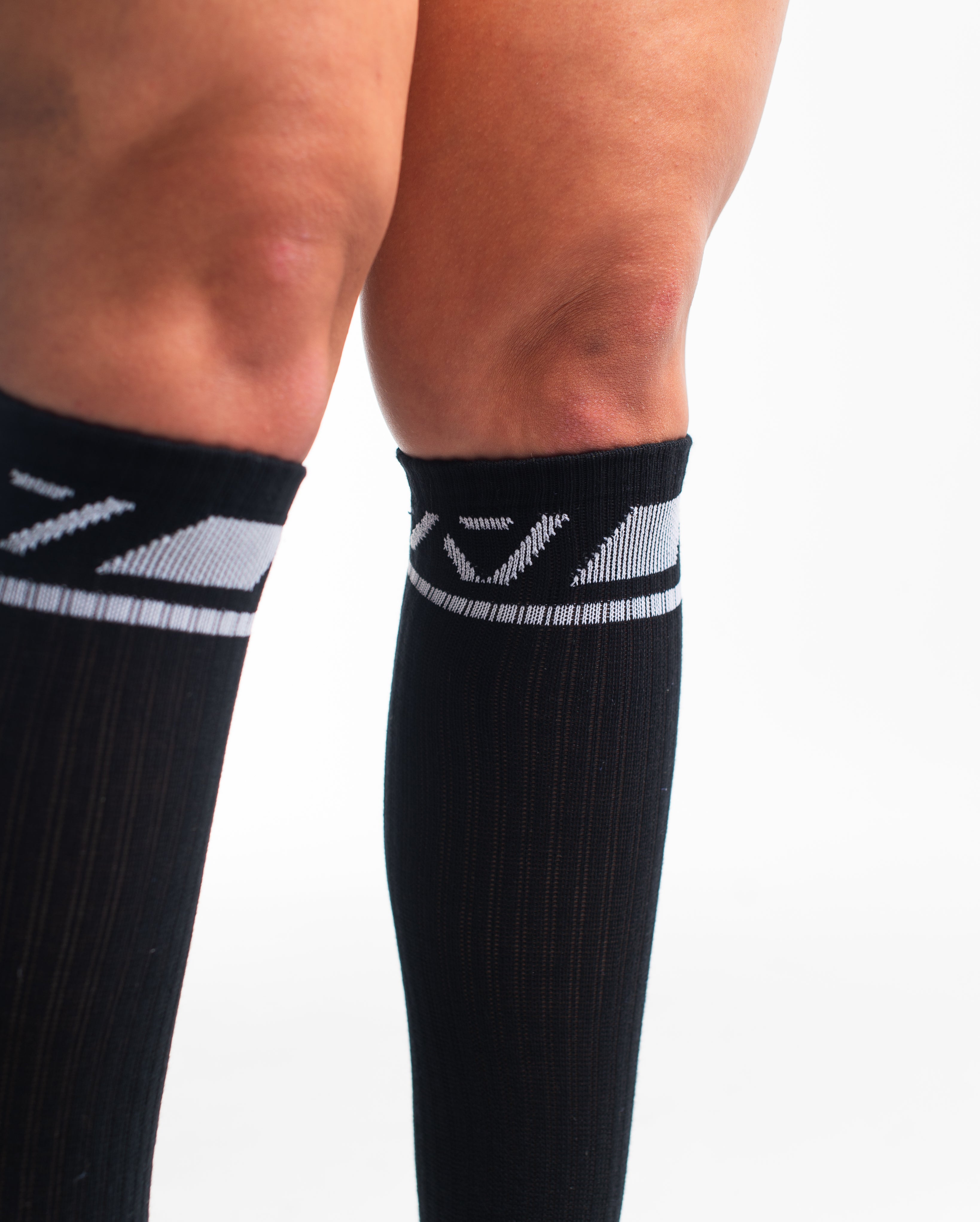 Close-up of the knit fabric on A7 Deadlift Socks in Domino Black, showing texture and stitching details.