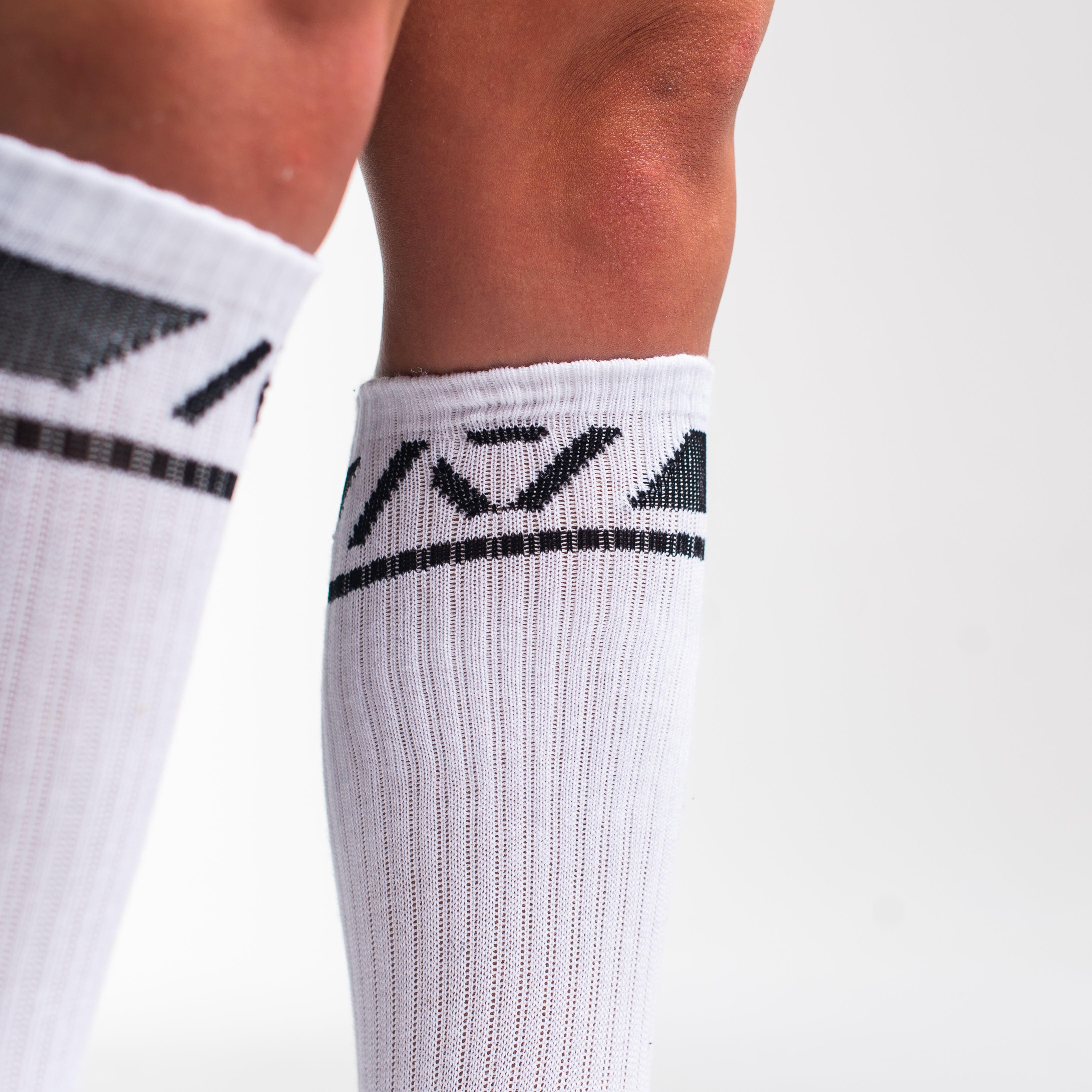 Close-up of the knit fabric on A7 Deadlift Socks in Domino White, showing texture and stitching details.