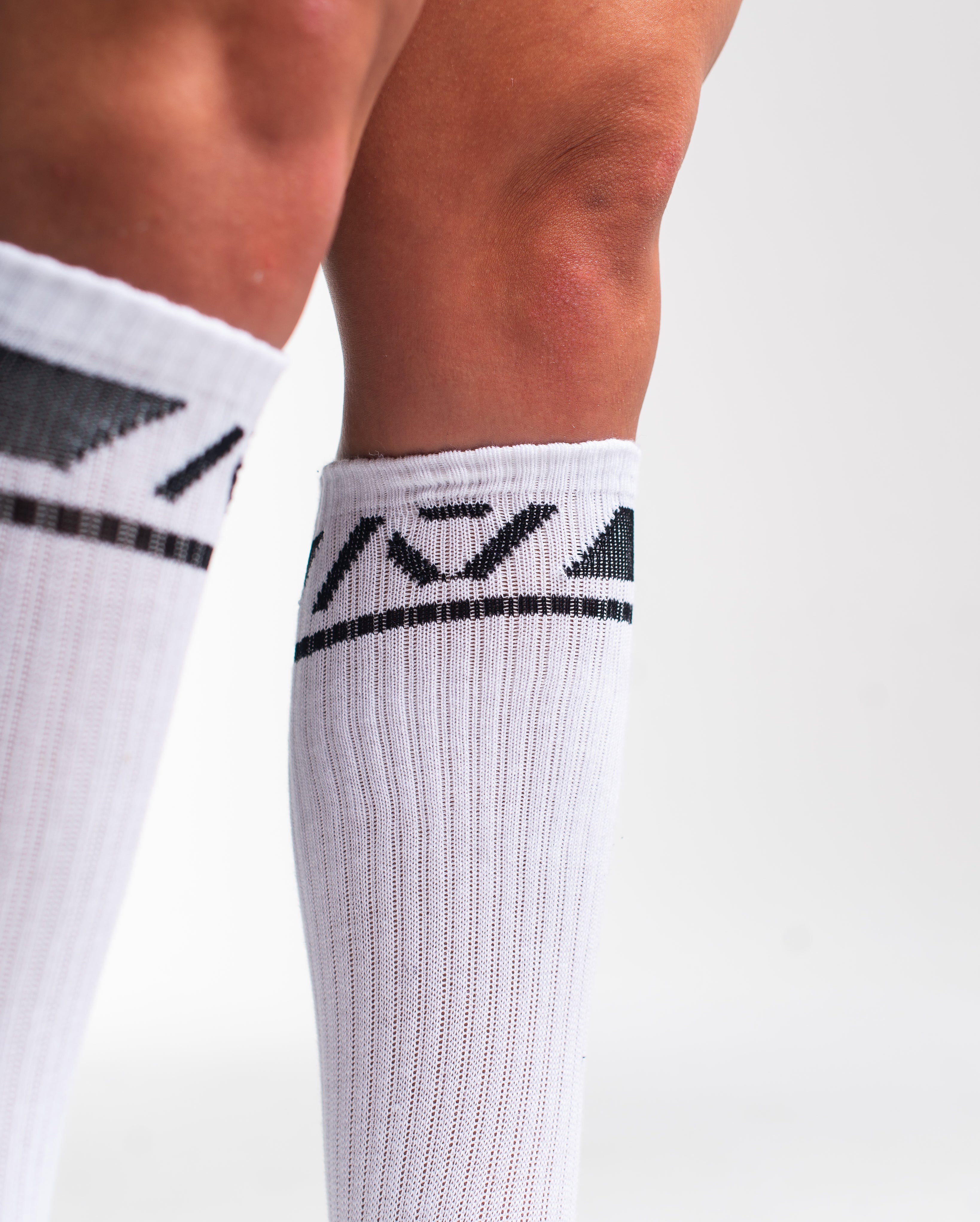 Close-up of the knit fabric on A7 Deadlift Socks in Domino White, showing texture and stitching details.