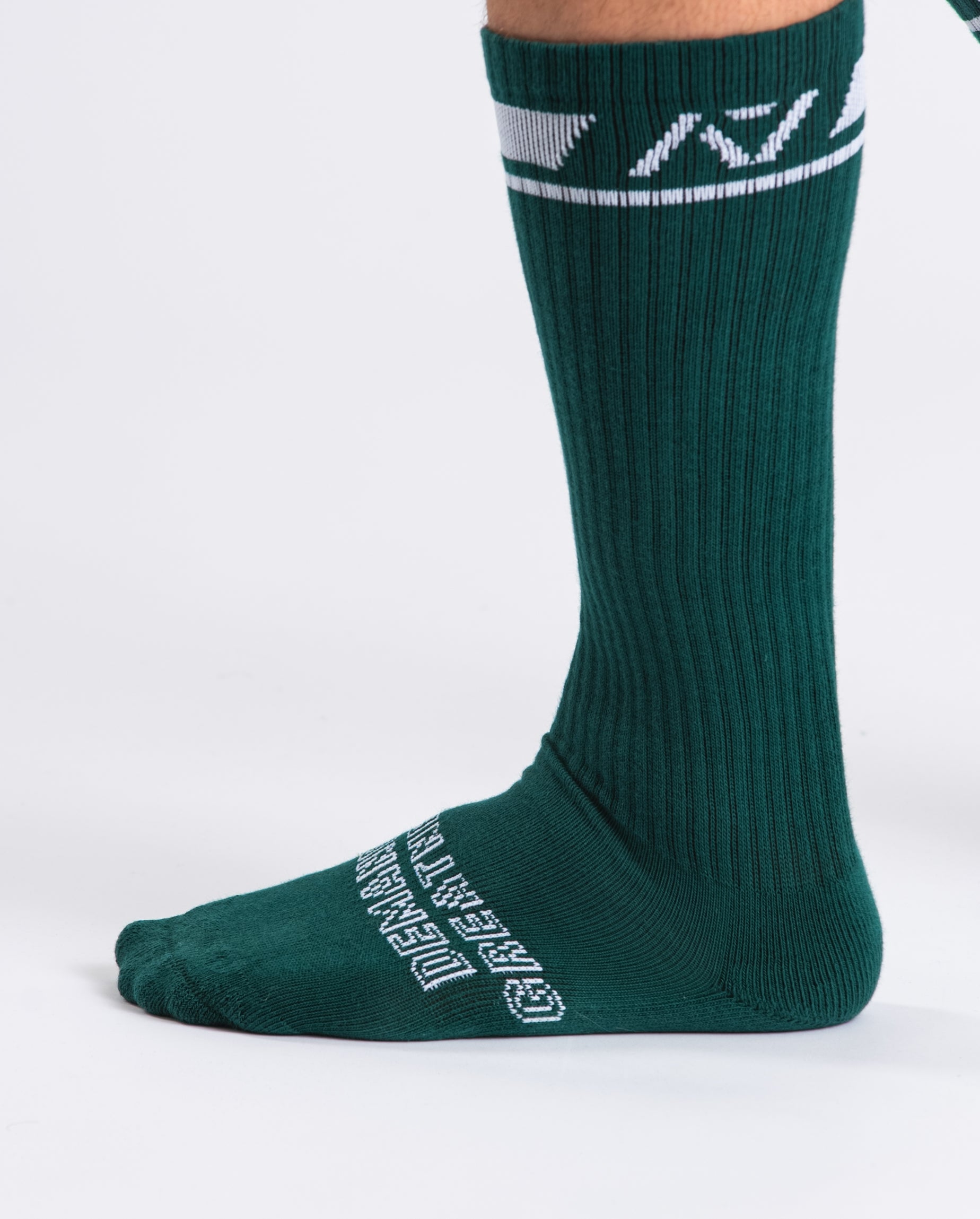 Close-up of the knit fabric on A7 Deadlift Socks in Emerald Forás, showing texture and stitching details.