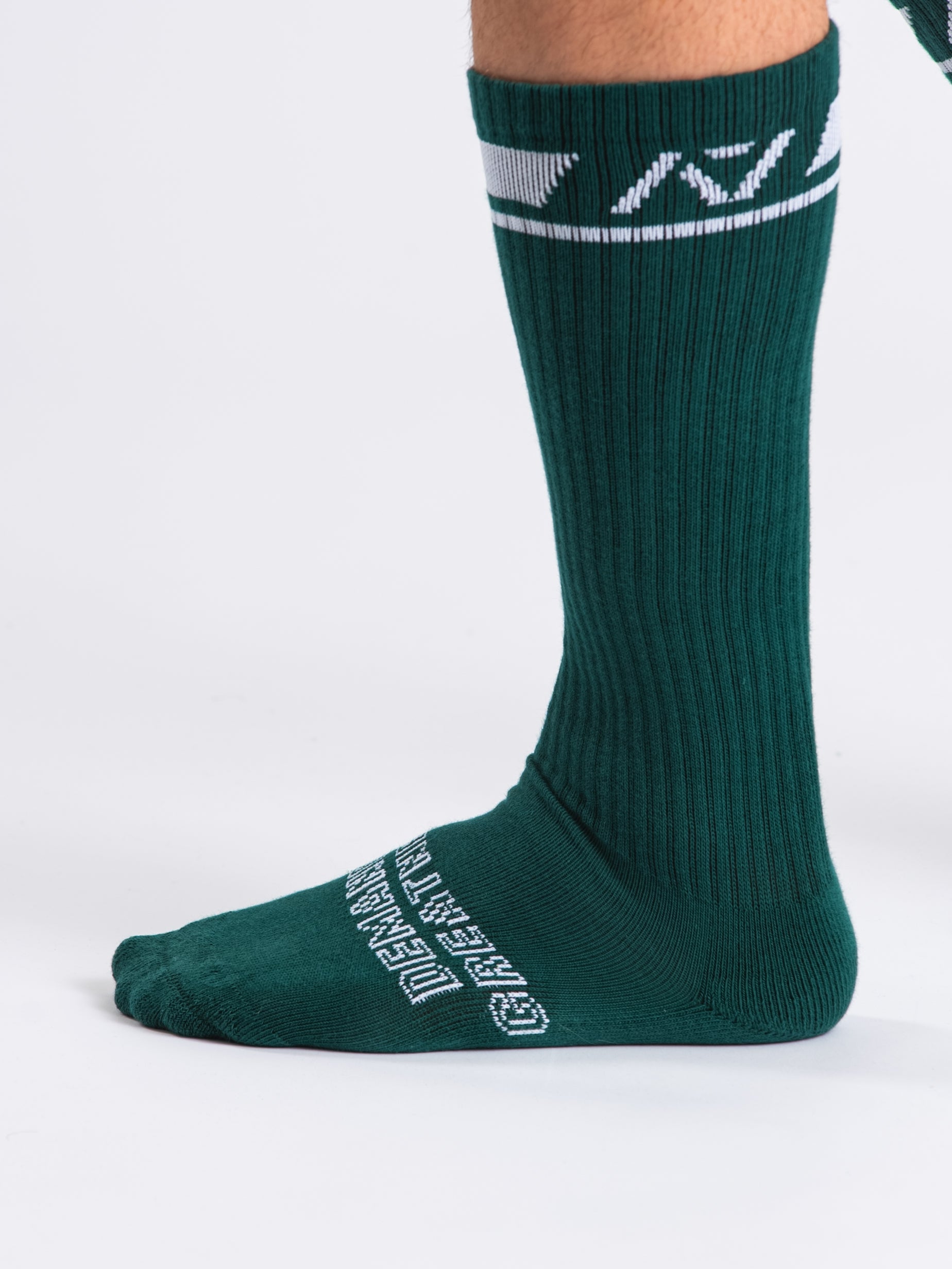 Close-up of the knit fabric on A7 Deadlift Socks in Emerald Forás, showing texture and stitching details.