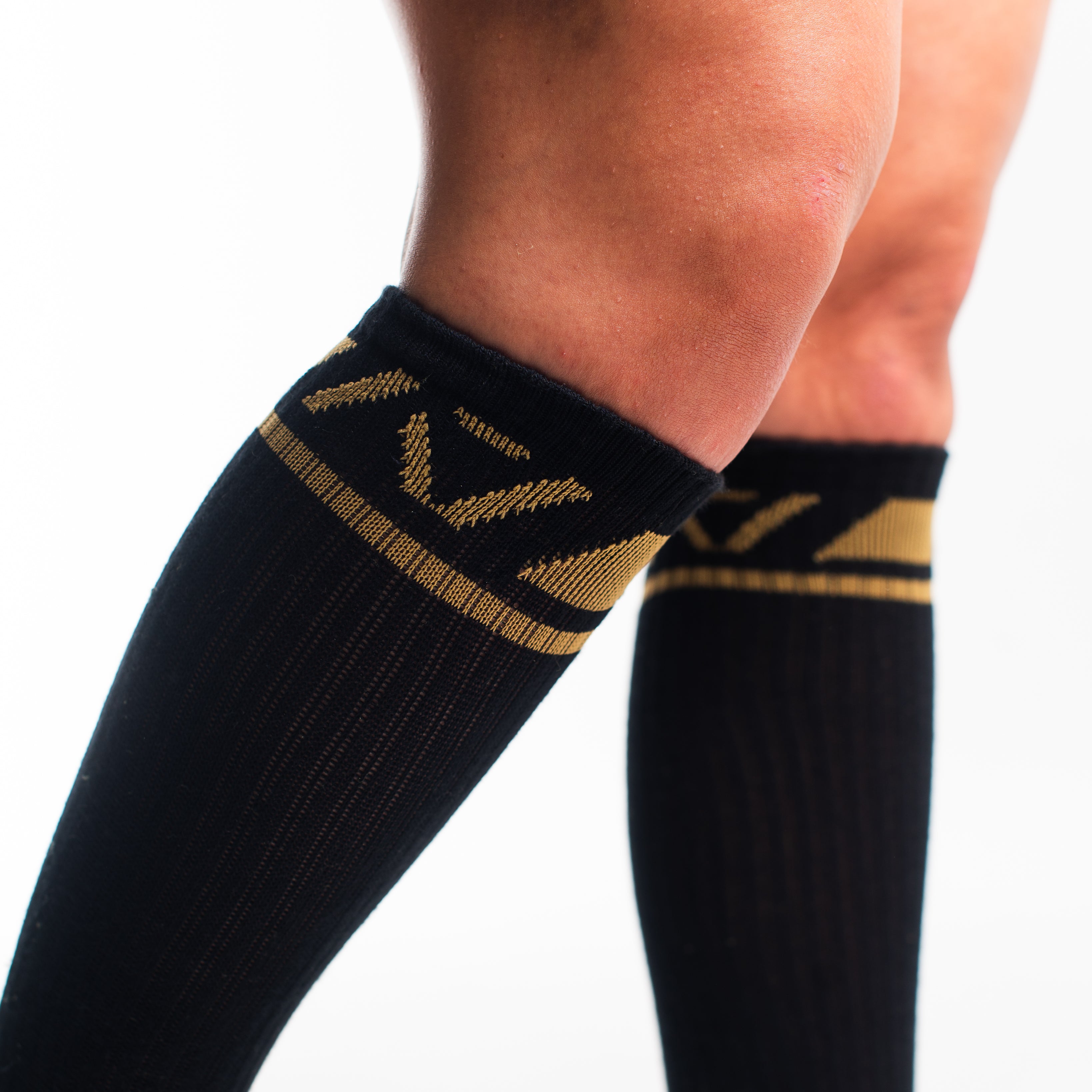Close-up of the knit fabric on A7 Deadlift Socks in Gold Standard, showing texture and stitching details.