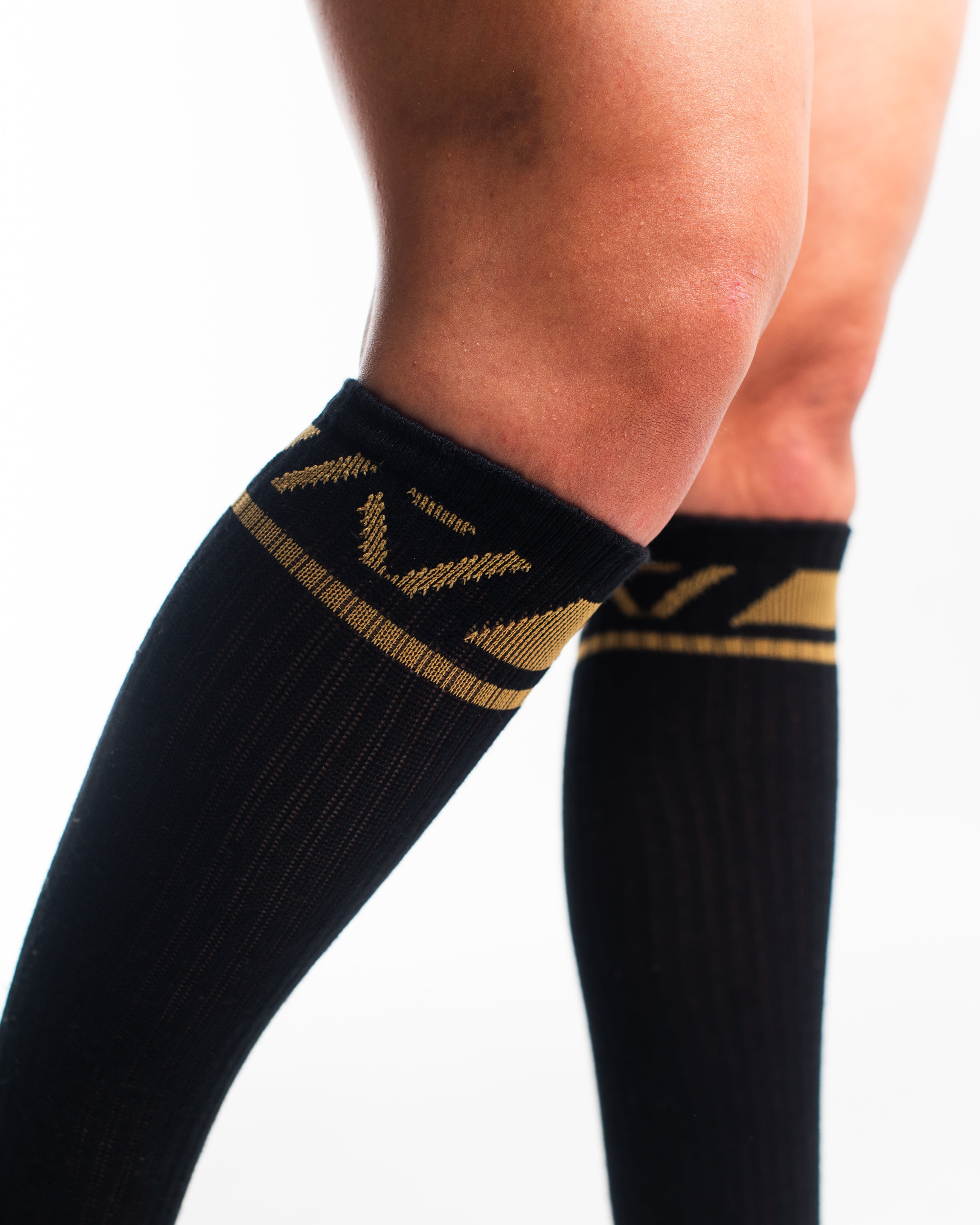 Close-up of the knit fabric on A7 Deadlift Socks in Gold Standard, showing texture and stitching details.