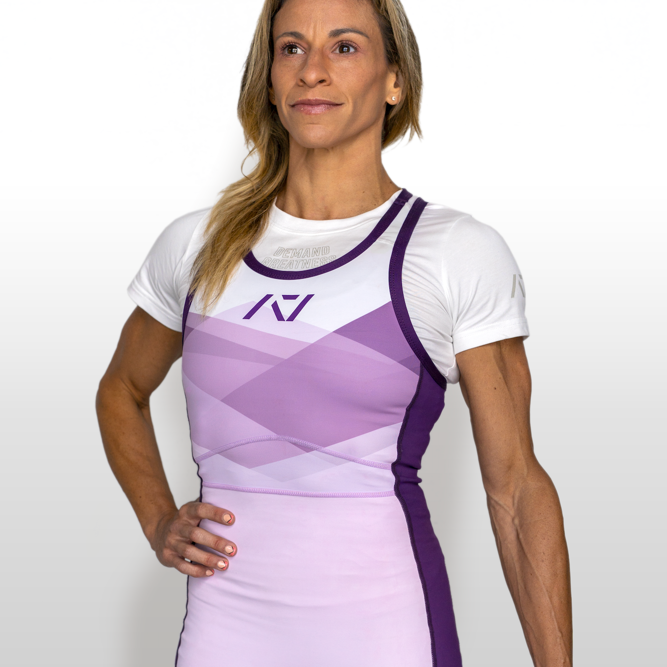 Woman wearing a white and purple IPF approved singlet with a logo on a white background