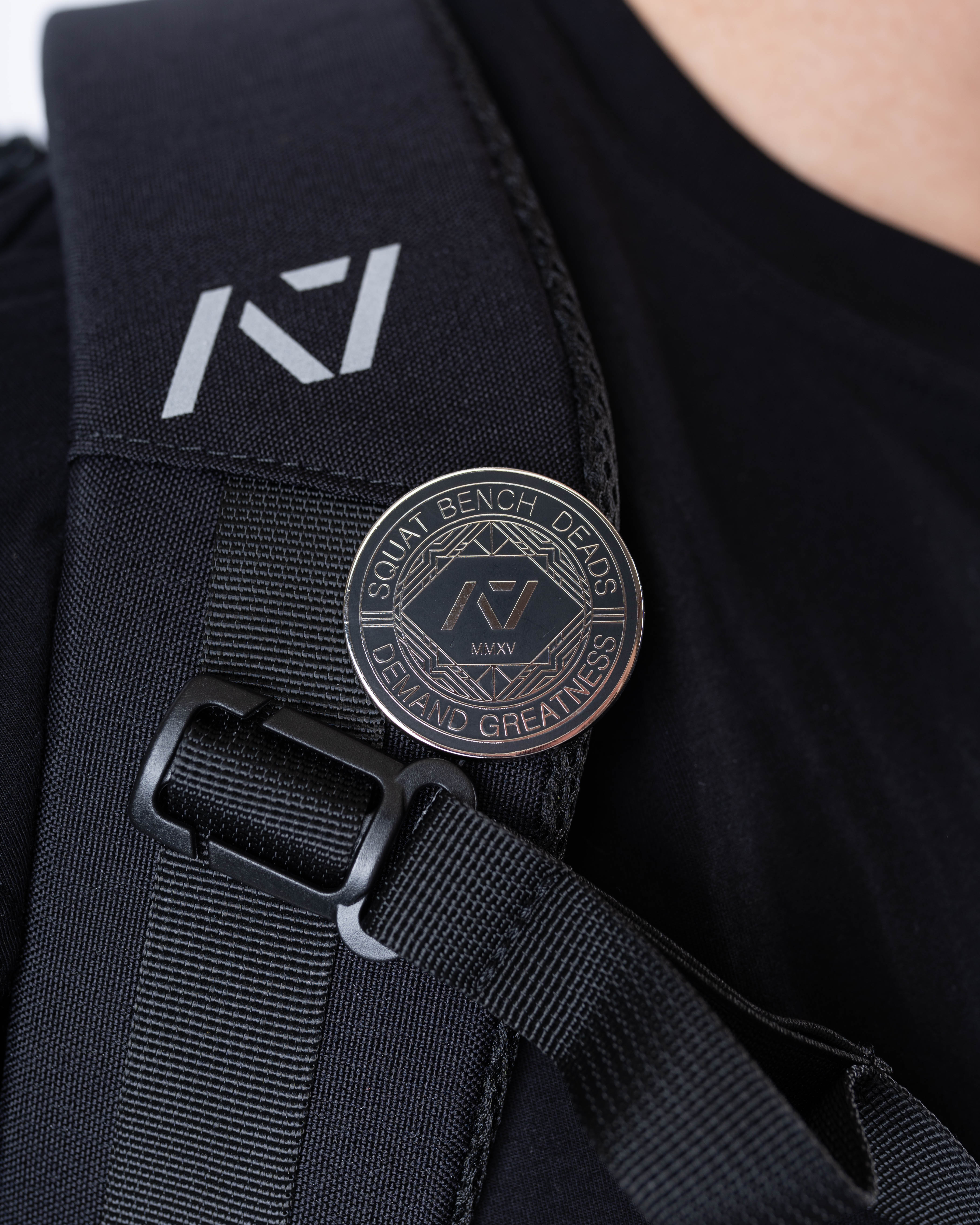 A7 Revive Pin attached to a gym bag strap, showing practical use and symbolic representation for lifters.