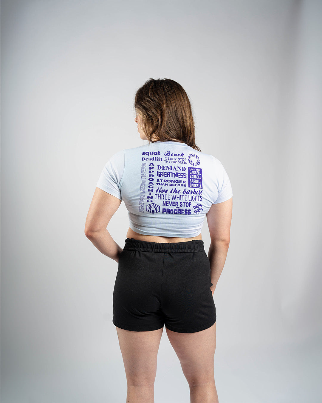 Back view of A7 Affirmation True-Fit Women's Crop – Pastel showcasing motivational mantras in white text on pastel fabric.