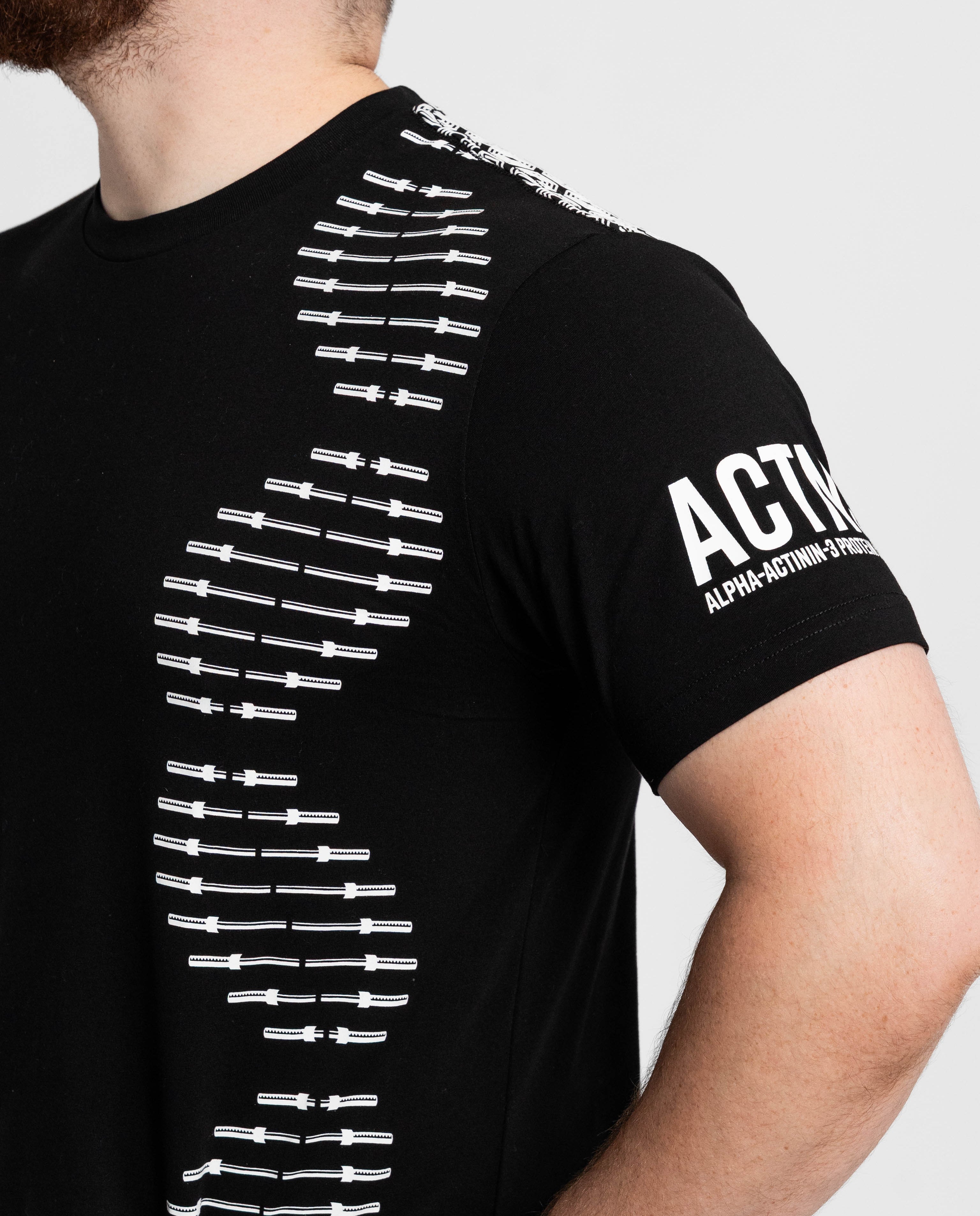 Black t-shirt with white graphic design on a gray background